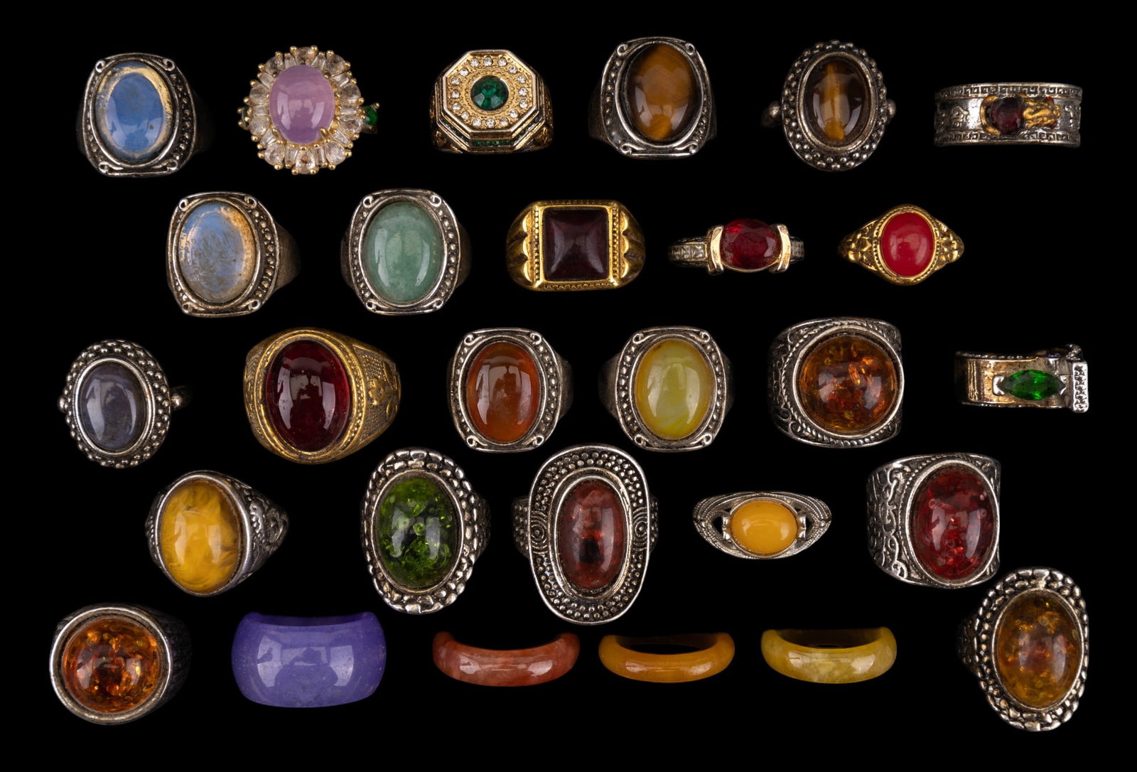 Tiger's Eye, Moonstone, & Other Hardstone Rings: 28 total rings, including tiger's eye, moonstone, green hardstone cabochons, yellow hardstone cabochons, red hardstone cabochons, a Chinese Pixiu adjustable ring, & more. Many rings are adjustable. No