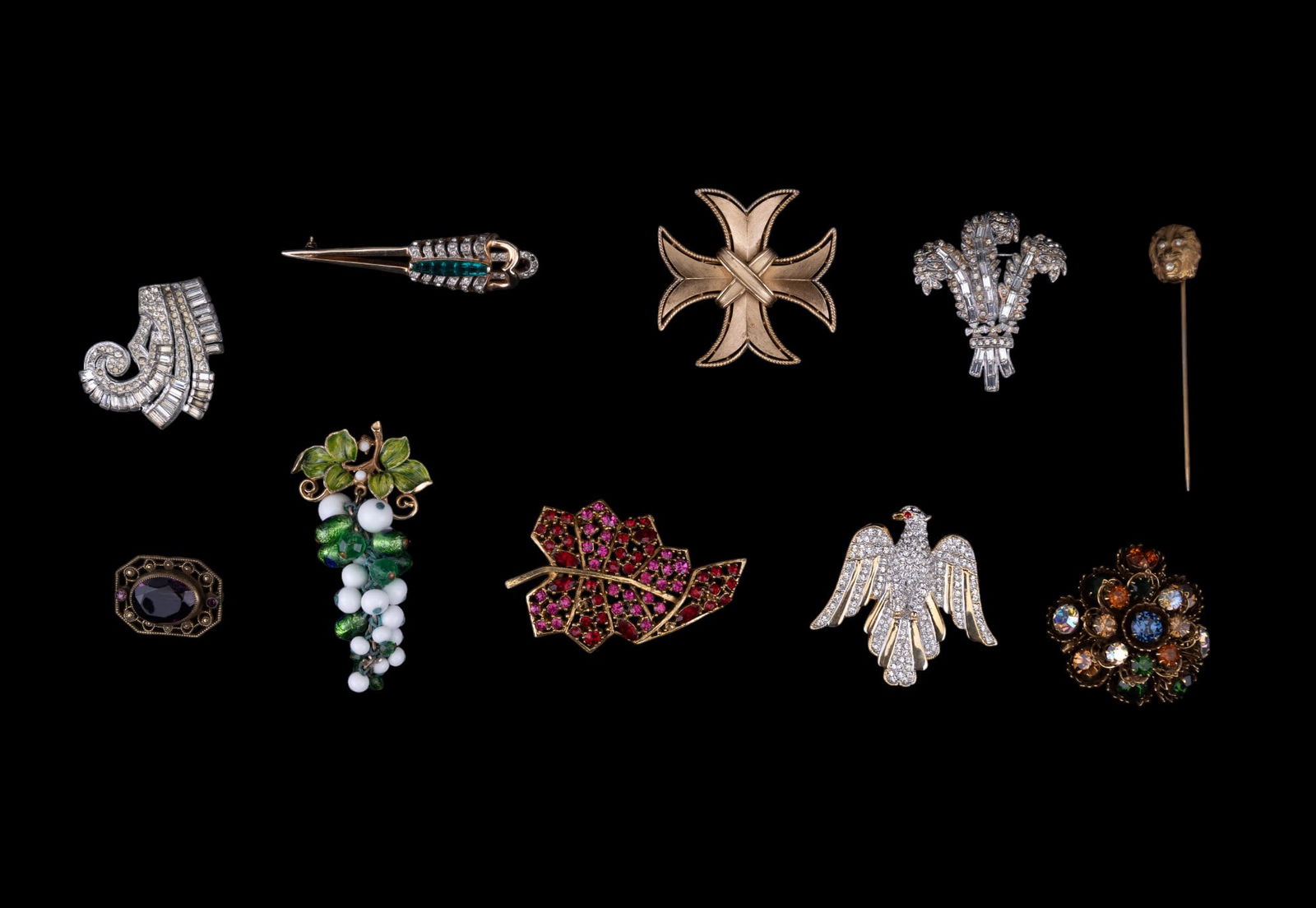 Trifari, Reja, and Estate Brooches: Trifari gold tone cross pin / pendant, Reja scepter, Coro, Carolee, gold tone lion stick pin, and other brooches.