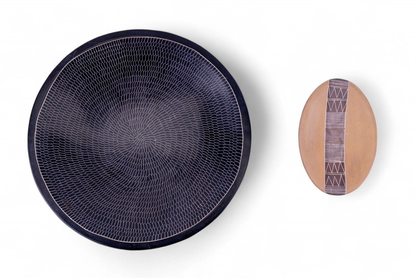 Hand Carved Kenyan Soapstone Plate and Dish: Large black coated soapstone plate with engraved designs marked "Made in Kenya" on bottom - measures approx. 1.5" H x 11" Dia. A small oval two toned dish of similar style and material is also include