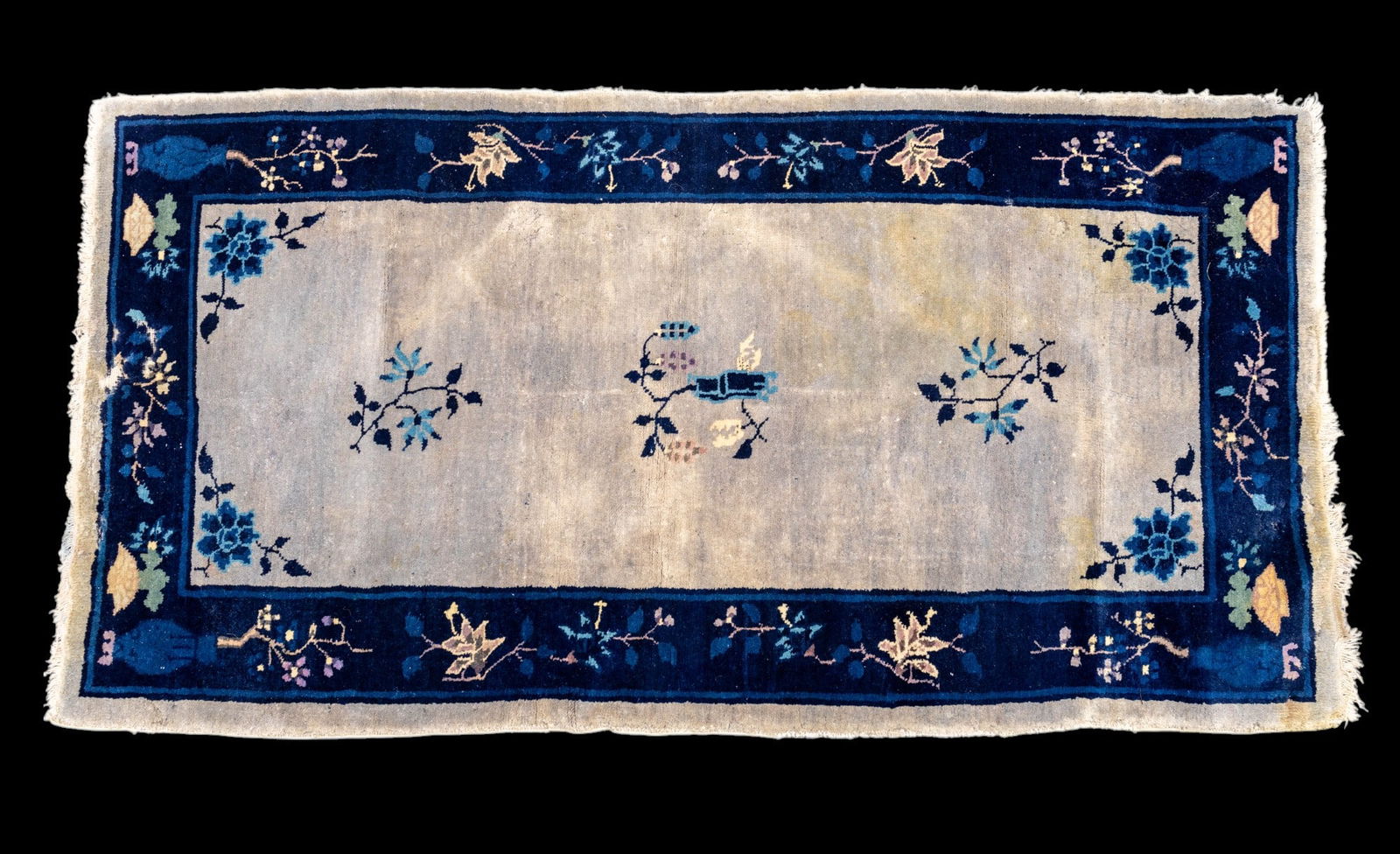 Chinese Art Deco Rug: Chinese Art Deco rug approx. 3'1" x 6'2" w/ navy blue, royal blue, livid bluish-grey, dull purple, purple, tan, & green design w/ vase and floral motifs. Staining on field. Some moth damage. *All rugs