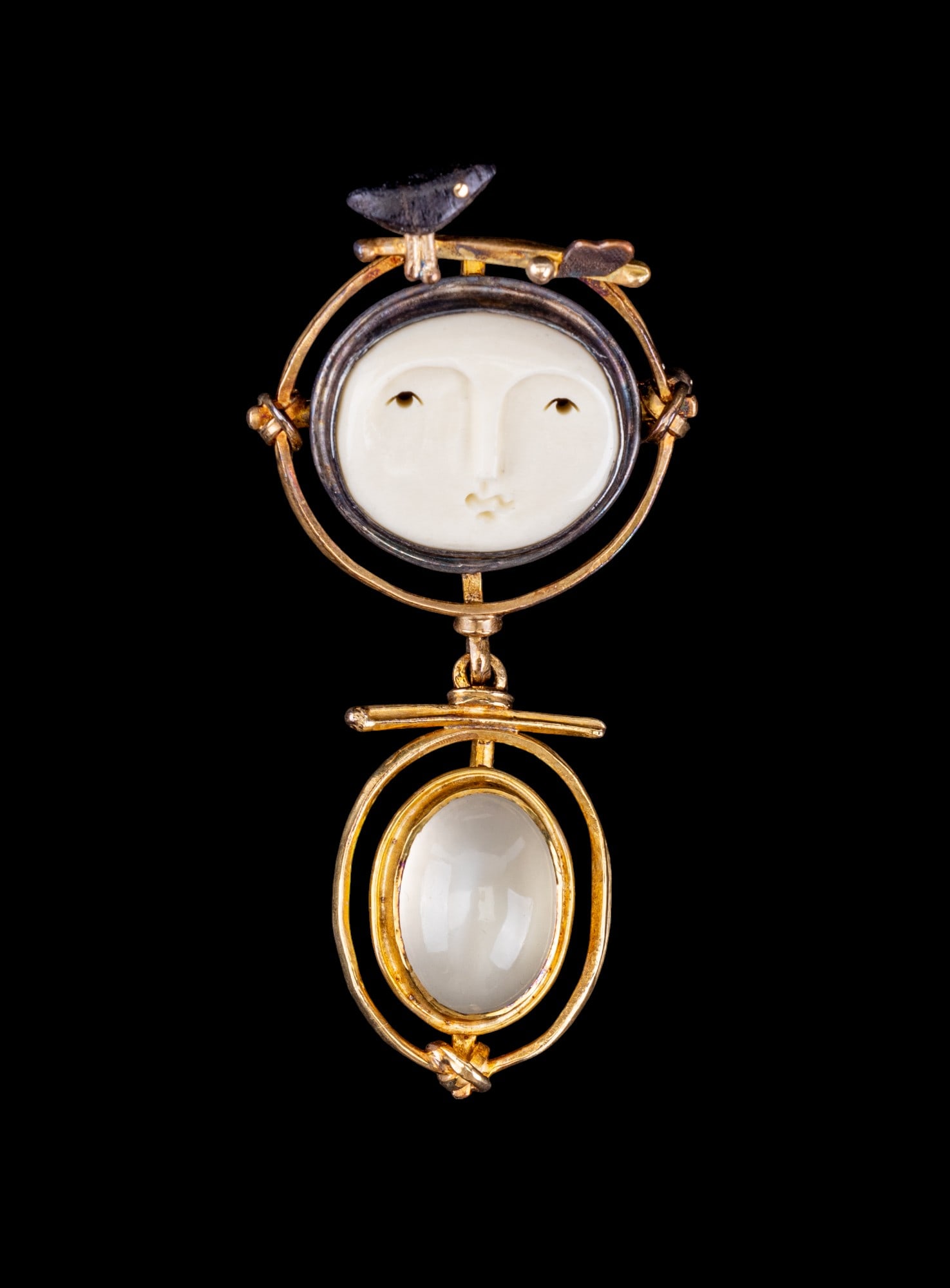 18K Gold Carolyn Morris Bach Brooch: 18K Carolyn Morris Bach brooch, hand crafted one-of-a-kind with smoky gray cabochon and carved natural material face, signed and marked 18K. As others are made with ebony and cow bone, likely the same