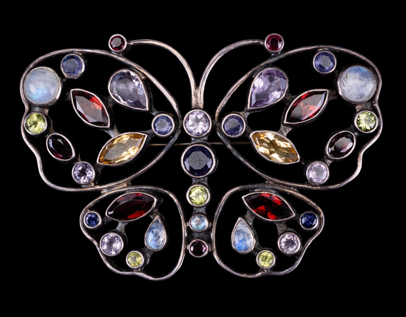 Nicky Butler Sterling & Moonstone Butterfly Brooch: Nicky Butler (NB) India .925 sterling silver butterfly brooch w/ moonstone accents on wings & abdomen & red, dull yellow, lavender, indigo, & light green rhinestone accents on the wings & body. Piece 