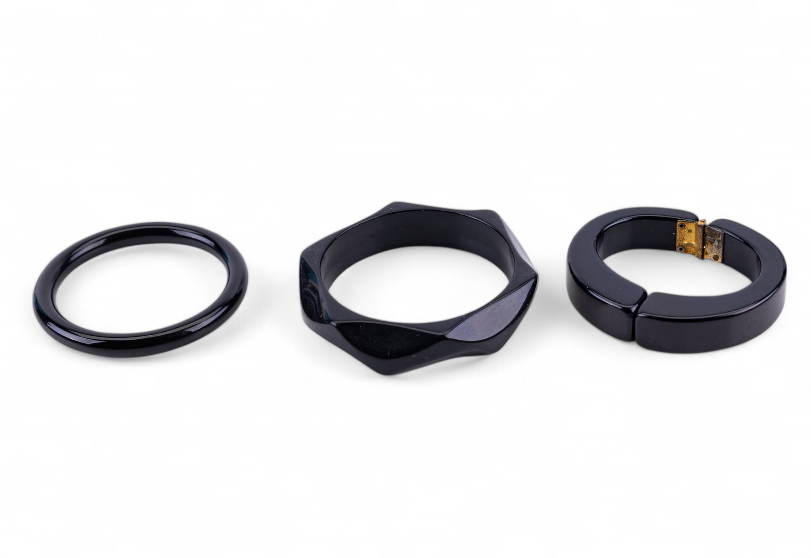Carved Wood and Acrylic Bangle Bracelets: A collection of 15 bangle bracelets featuring carved wood with mother of pearl and bone inlay, carved horn and bone, layered acrylic, and black glass. One layered acrylic ring size 8.