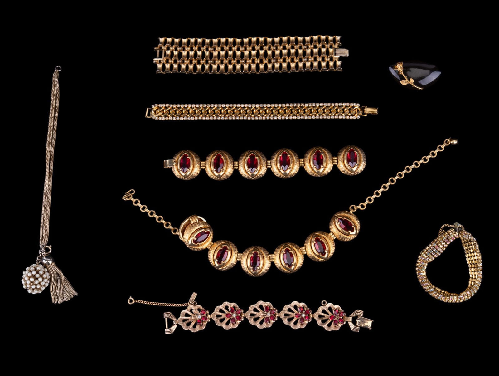 Gold Tone Vintage Jewelry: Large gold tone red rhinestone crystal matching large necklace and bracelet, fancy link bracelets with rhinestones, ebonized wood rose brooch, and more.