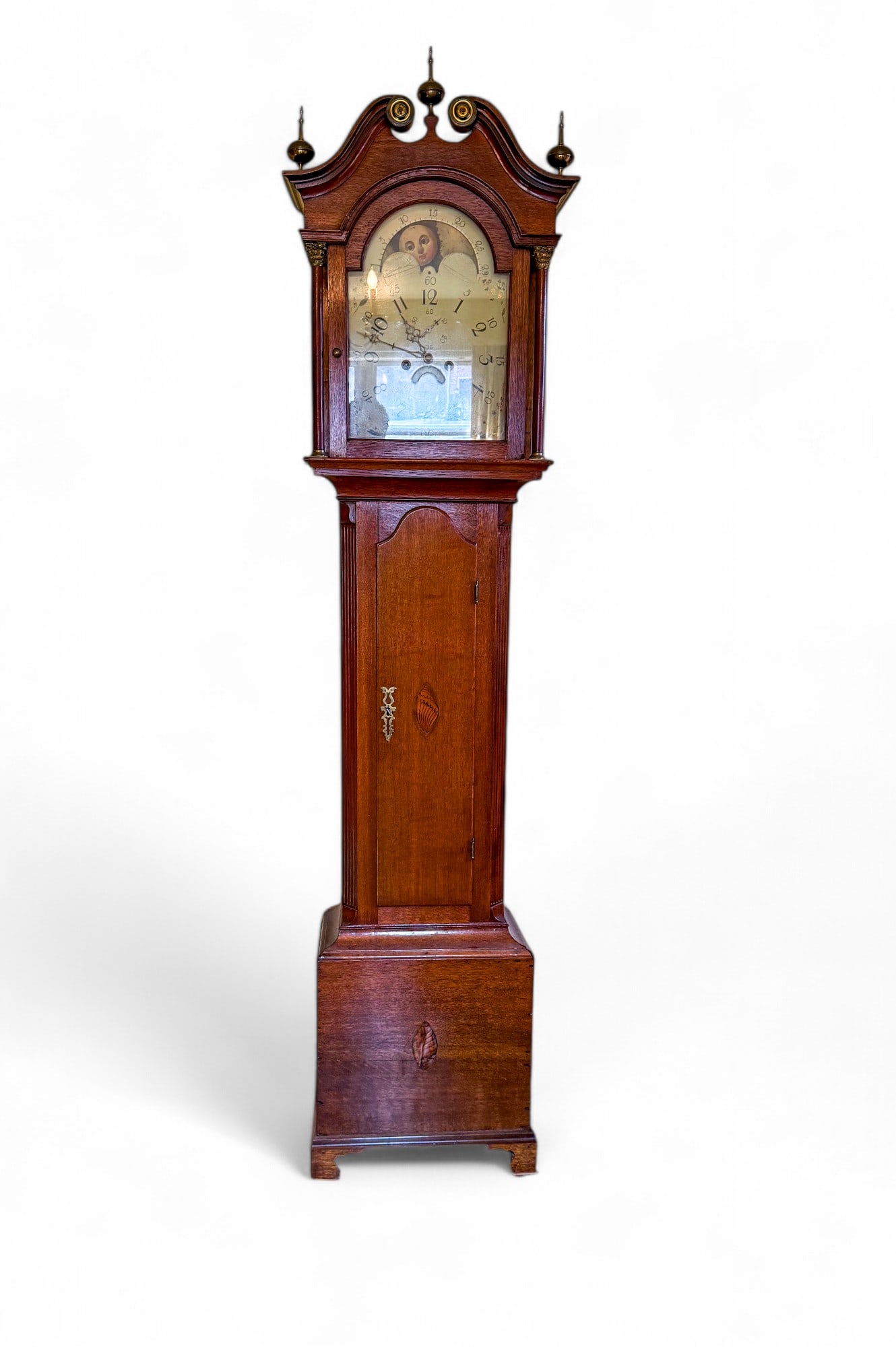 English/Scottish 8 Day Tall Case Clock: 19th century English/Scottish 8 Day tall case clock w/ hand-painted rotating clock face design of 2 moon faces, a ship, & a river scene w/ a cottage; an inlay shell design on the door & bottom of the