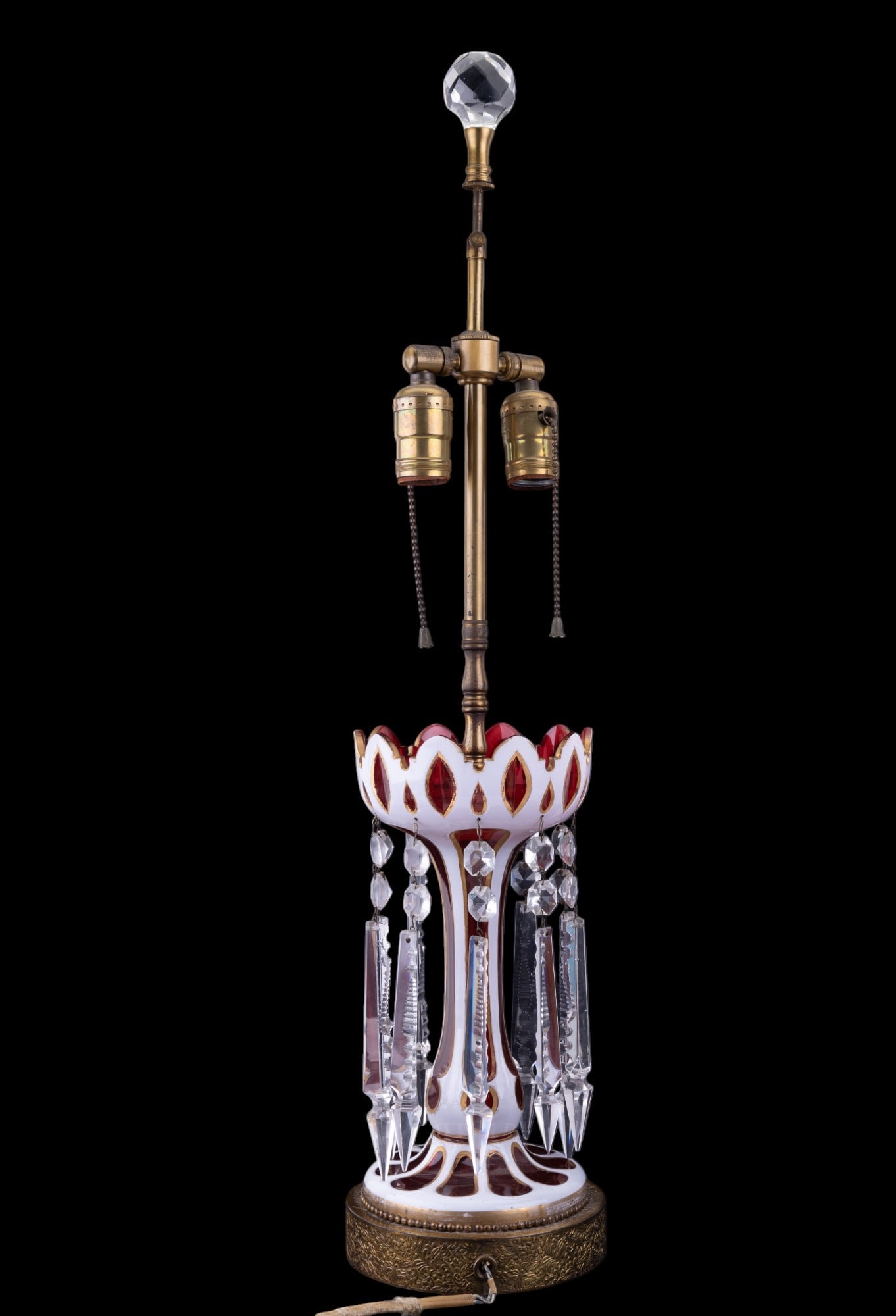 19th C Moser Bohemian Glass Lamp: Moser Bohemian enameled white to ruby red cut glass lamp w/ gilded highlights. Lamp has heavy lusters, a floral motif, & needs a new cord. Lamp is approx. 27.5" tall to top of finial.