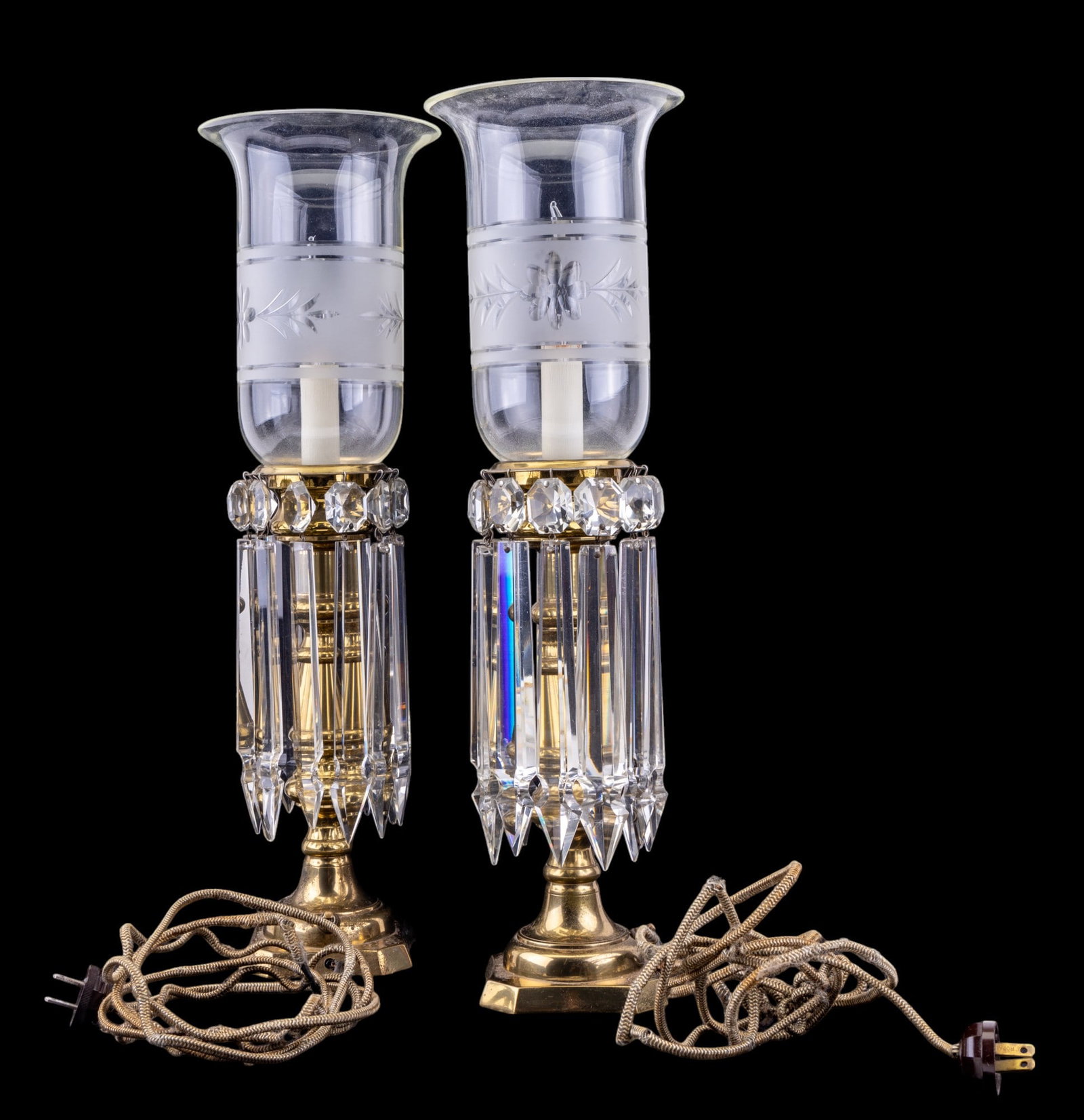 Pair Early Brass Lamps with Crystals: Pair of early 20th C lamps w/ brass bases, etched & frosted hurricane shades, & heavy lusters. Lamp could potentially use a new cord. Item is approx. 20" tall.