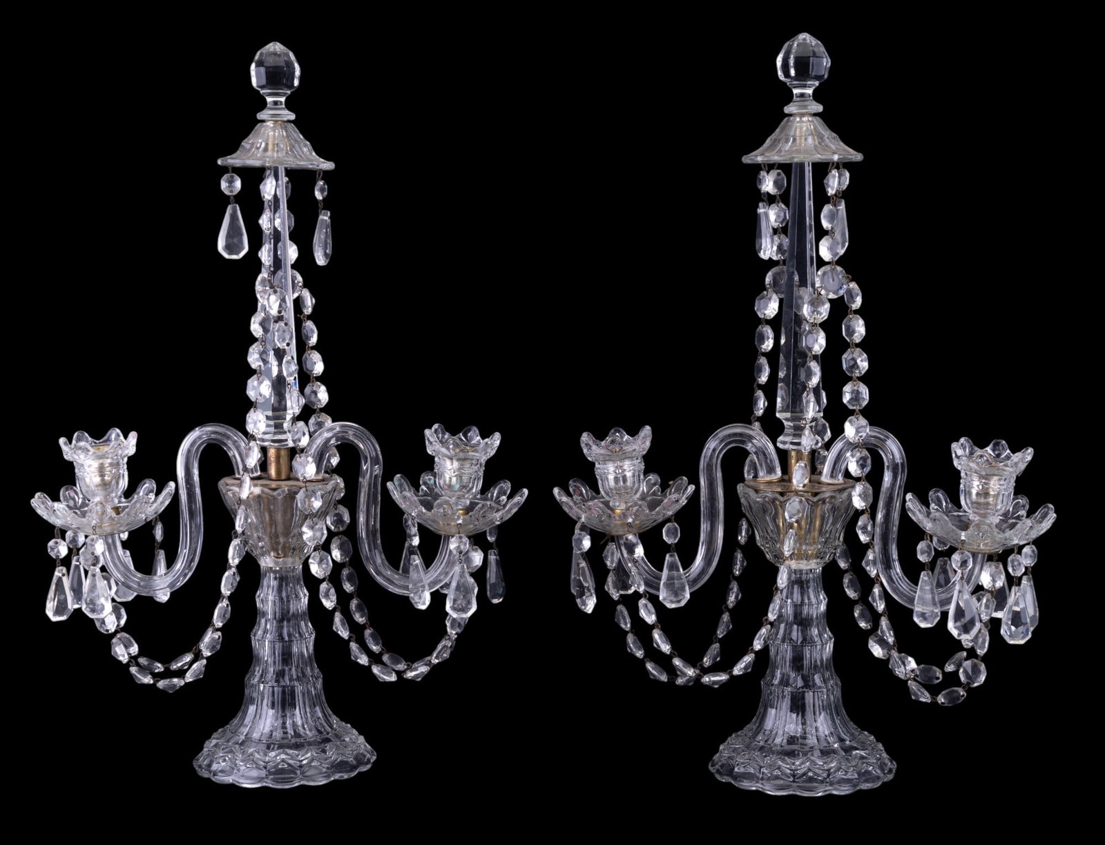 Pair of Elaborate Pressed Glass Candelabras: Pair of elaborate pressed glass candelabras approx. 20" tall w/ hanging crystals. One crystal is missing at the top, potentially missing more crystal drops (not verified).