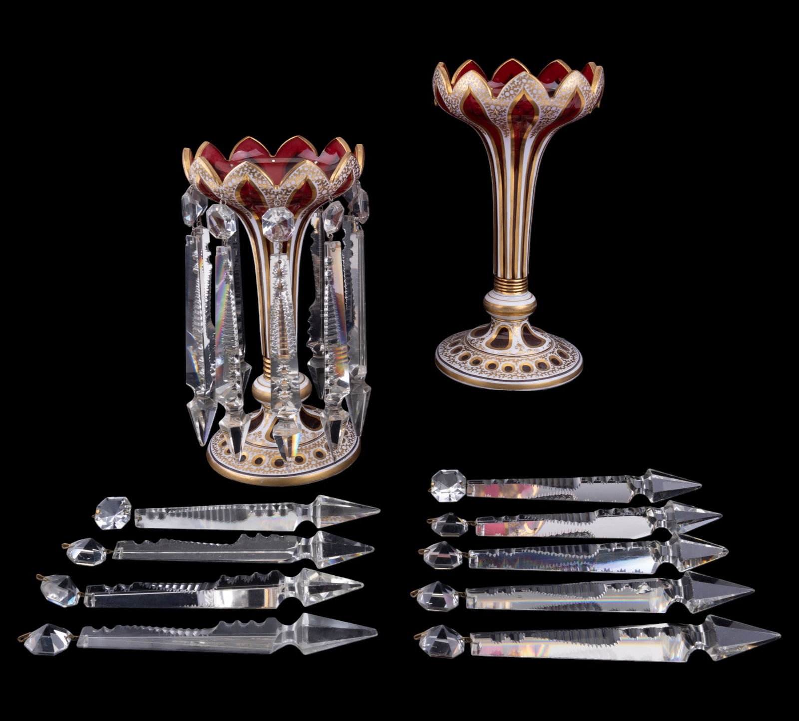 Pair Moser/Bohemian Glass Vase Centerpiece: Pair of 19th C Moser Bohemian glass flower vases w/ lusters, measuring approx. 10.5" tall & 6" in diameter. Glass is cranberry-colored w/ white & gilded accents. Vases have heavy crystal lusters & flu