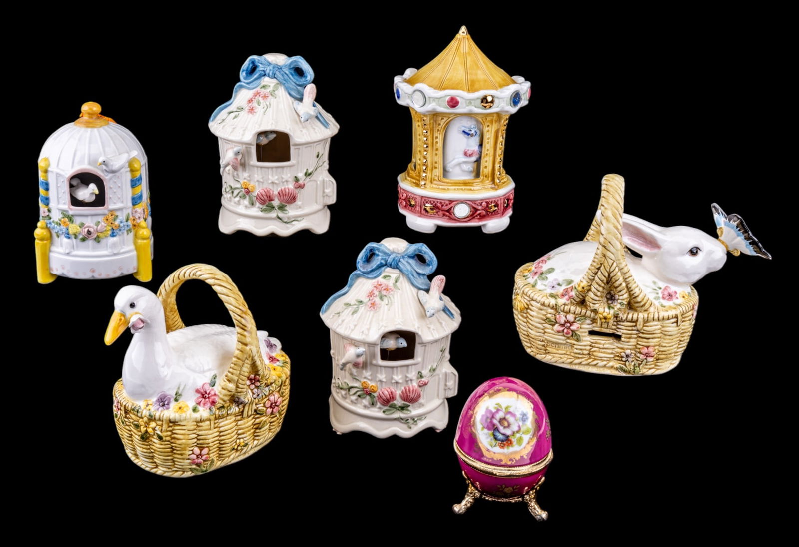 5 Schmid Music Boxes, Japanese Egg Music Box: 5 Schmid music boxes & Japanese porcelain egg music box. Designs feature a white goose, a rabbit, & little houses. Tallest box is approx. 7" tall.