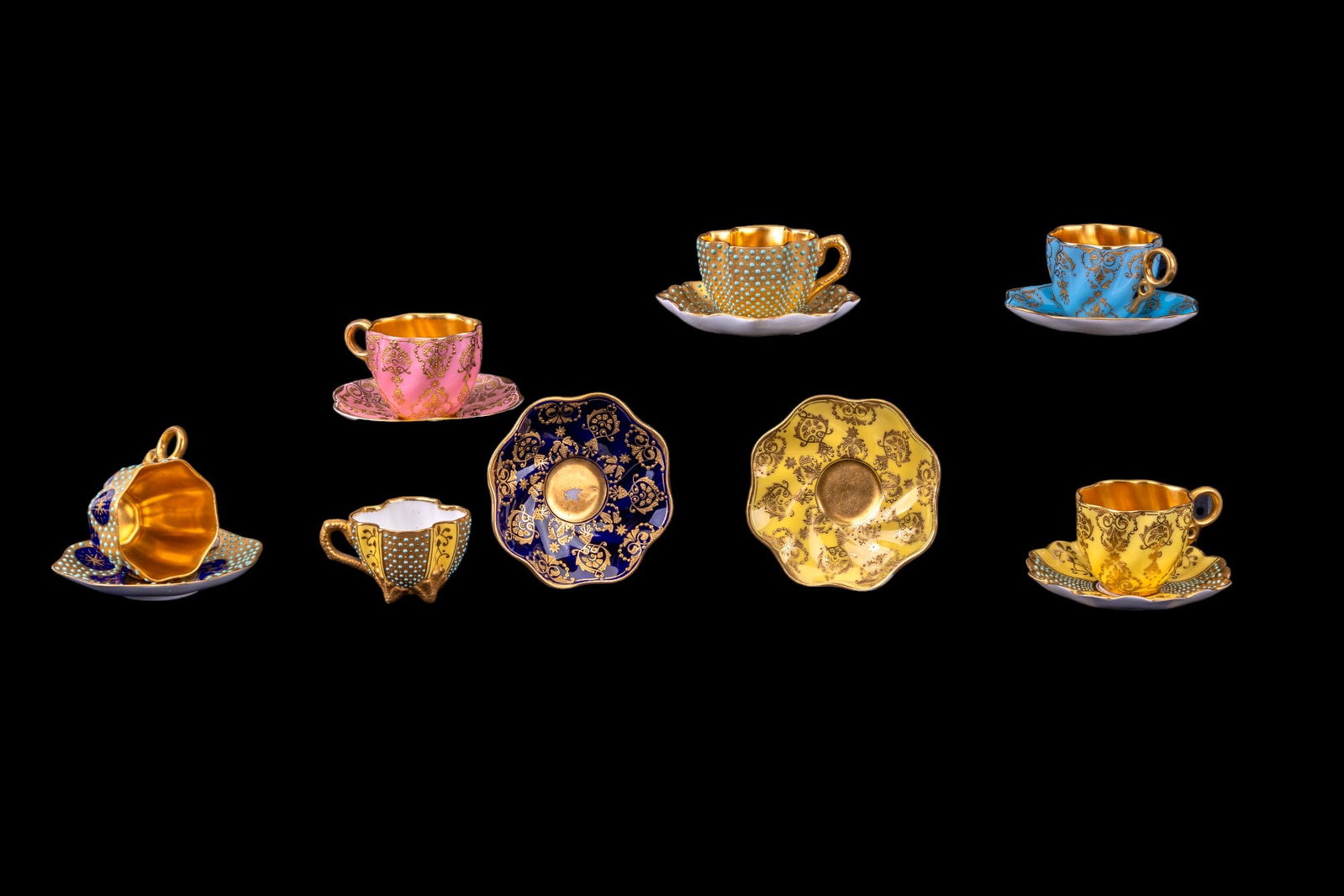 Coalport Porcelain Cups & Saucers: Set of 6 Coalport highly-decorated enameled & gilded diminutive cups & saucers w/ cobalt blue & spring colors, plus an additional saucer. Saucers are approx. 3.25" in diameter. Refer to picture three,