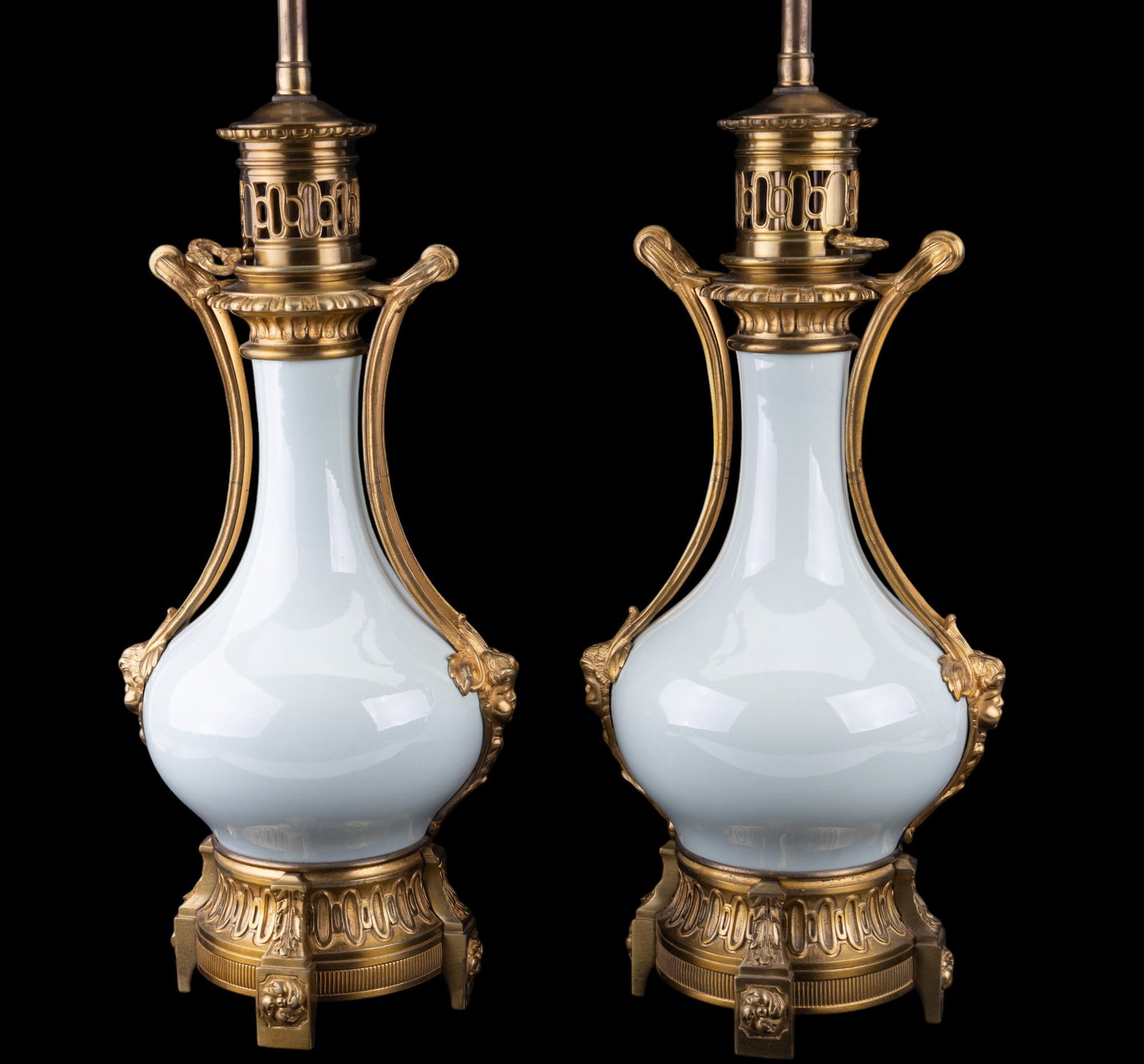 Lamp Pair - Bronzed Cast & Celadon Porcelain: Pair of celadon porcelain table lamps w/ highly-detailed bronzed castings w/ angels in a Neoclassical design and approx. 28" H to top of finial.