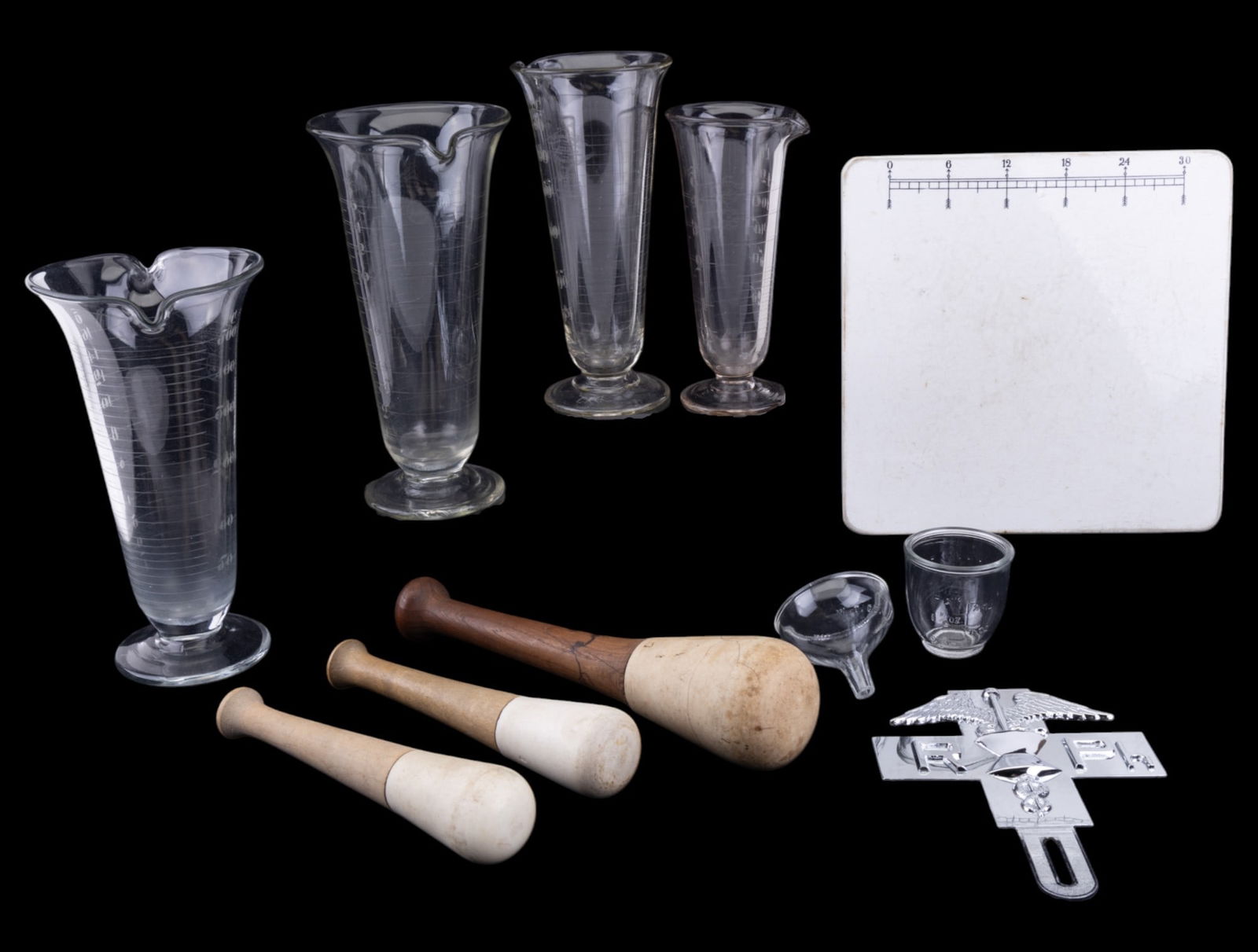 Glass Beakers, Pestles, Porcelain Slab: Vintage porcelain pill tile slab 10x10", three vintage wood and porcelain pestles, four glass beakers of different volumes by Armstrong Cork Co Whitall Tatum Dept, and a Pharmacist's license plate pla