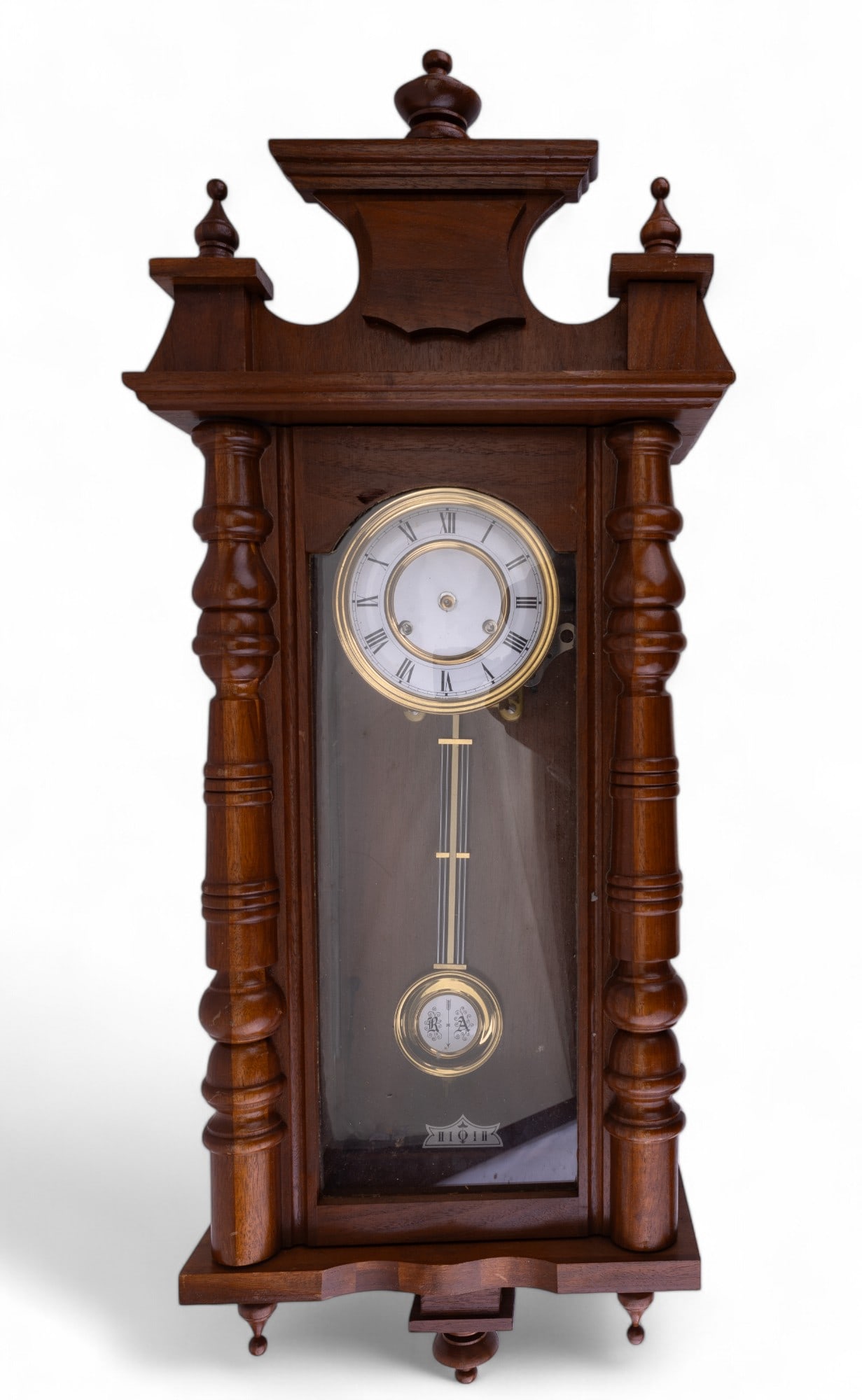 German Made Wall Clock: German made case clock with loose face & key included. Measures approx. 26.5" tall without top finial. Some chipping to wood. Top finial measures approx. 8" tall. Untested.