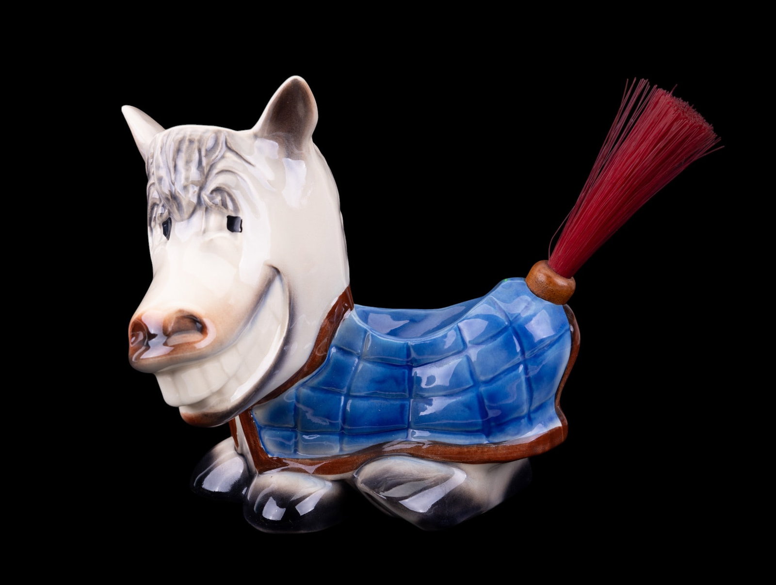 Vintage McCoy Smiling Donkey Dresser Caddy: Vintage McCoy ceramic smiling donkey dresser caddy with wood handled tail brush. Donkey measures approx. 8.75" H x 12" L x 6.5" W and has some crazing.