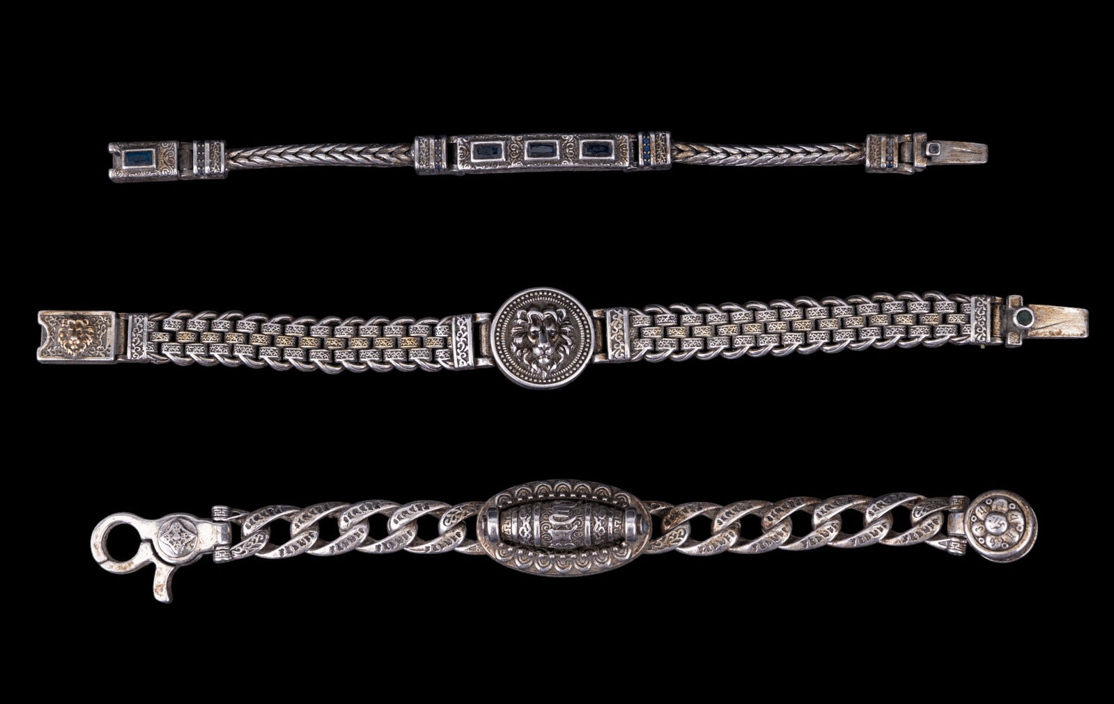 Tibetan Gusmi Mang Prayer Wheel Bracelet, 2 Others: Tibetan Gusmi Mang 2021 Buddhist prayer wheel silver tone bracelet approx. 7.5" long, silver tone lion head medallion bracelet, & another Tibetan silver tone bracelet w/ deep blue rhinestone accents.