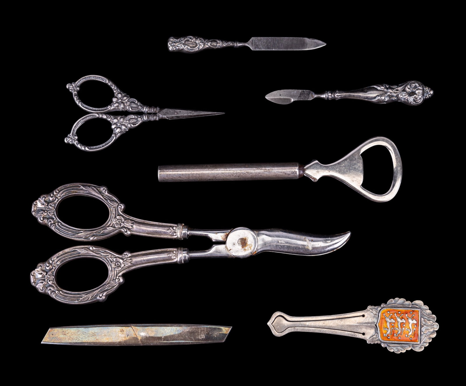 Tiffany, Doskow, & Other Sterling Silver Tools: Sterling handle grape shears w/ floral motifs, sterling silver Germany embroidery scissors w/ floral motifs, sterling letter opener w/ small hallmark, sterling nail file, Tiffany & Co. W. Germany ster