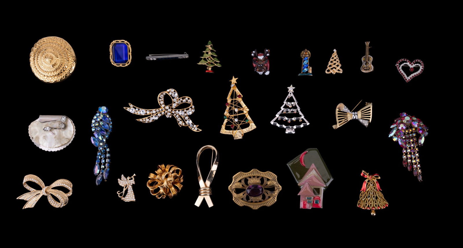 Monet, Kramer, Christmas Tree, & Other Brooches: Monet trumpeting angel gold tone brooch w/ crystal rhinestones, Monet gold tone circular Etruscan Revival brooch, Kramer silver tone & mother-of-pearl brooch, Roman gold tone ribbon bow brooch w/ crys