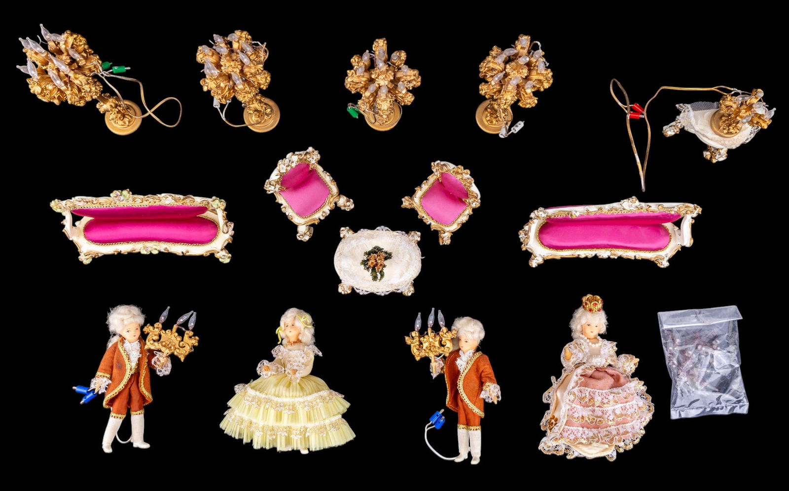 Boutique Szalasi Rococo Dolls and Furniture: A collection of Boutique Szalasi Rococo furniture including two sofas, two parlor chairs, coffee table candelabra on a demilune table, four standing ornate gold painted candelabra, two female dolls in