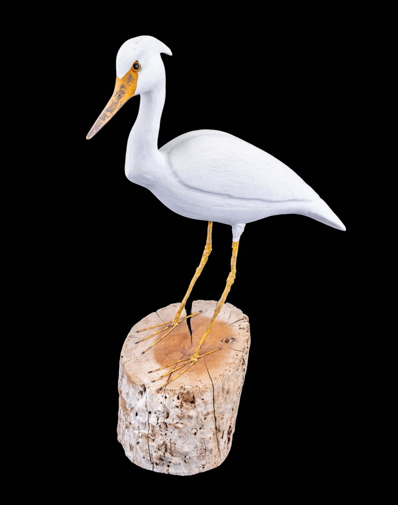 Herb Daisey Jr Shore Bird Statue: Hand carved and hand painted wood statue of a heron set on driftwood log slice, signed and dated Herb Daisey Jr, 1994, 14x19"