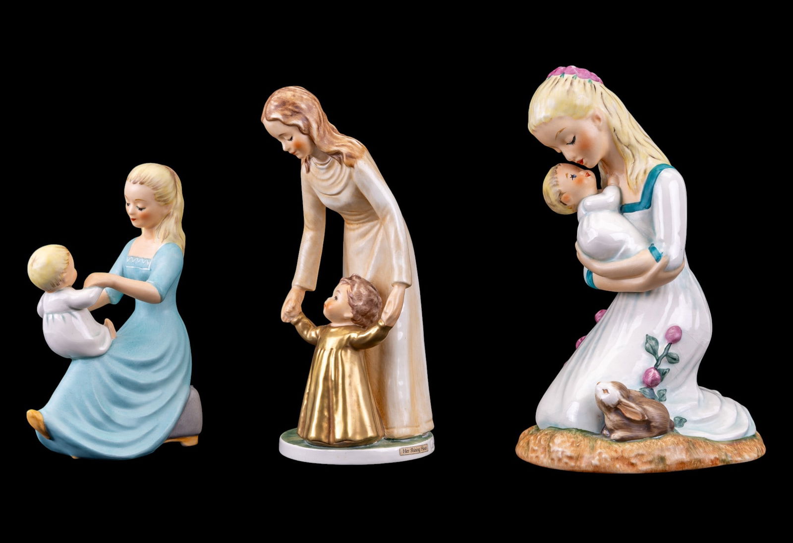 M. I. Hummel Figurines: Her Shining Hour BYJ56 8", Rock-a-bye Baby BYJ37 6.5", and Mother Embracing Child BYJ36 8.5". No chips or cracks.