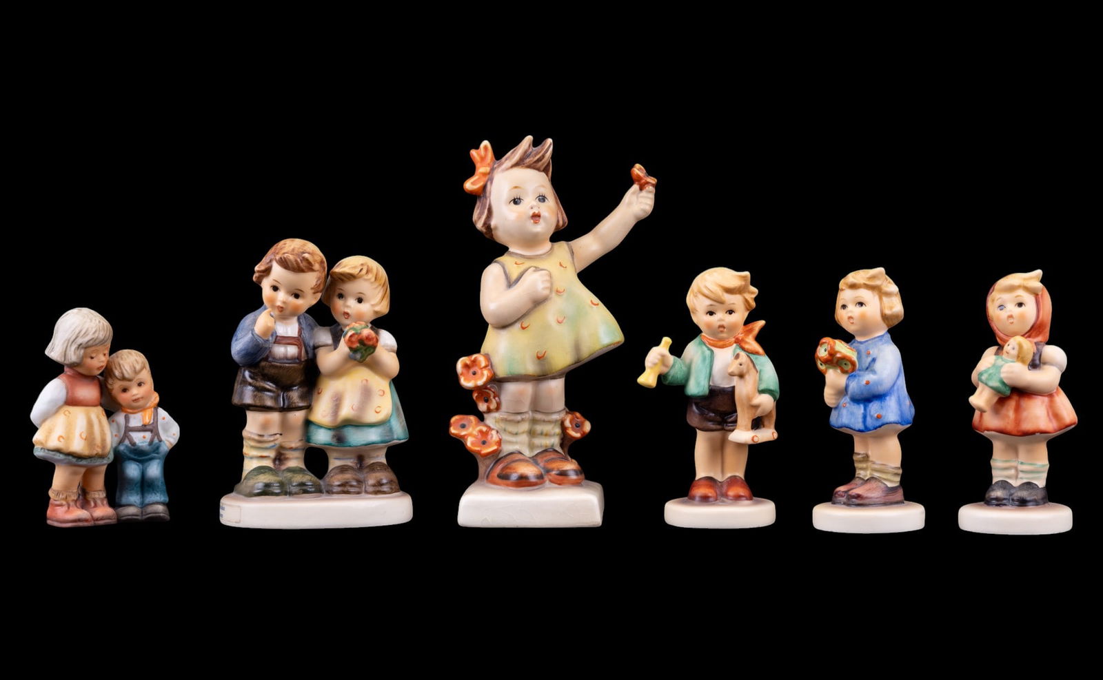 M. I. Hummel Figurines: Spring Cheer #72 5", Goes with Nosegay #239A 3.5", We Congratulate #220 4", Boy with Horse #239C, Girl with Doll #239B 3.5", and a Goebel 1997 Berta Hummel Christmas ornament, hanging ring appears to