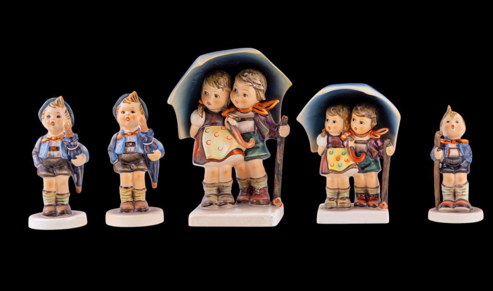 M. I. Hummel Figurines: Stormy Weather #71 1/0 6" and #71 3/0 5", Home From Market (x2) #198 2/0 5", and Little Hiker #76 2/0 4". No chips or cracks.
