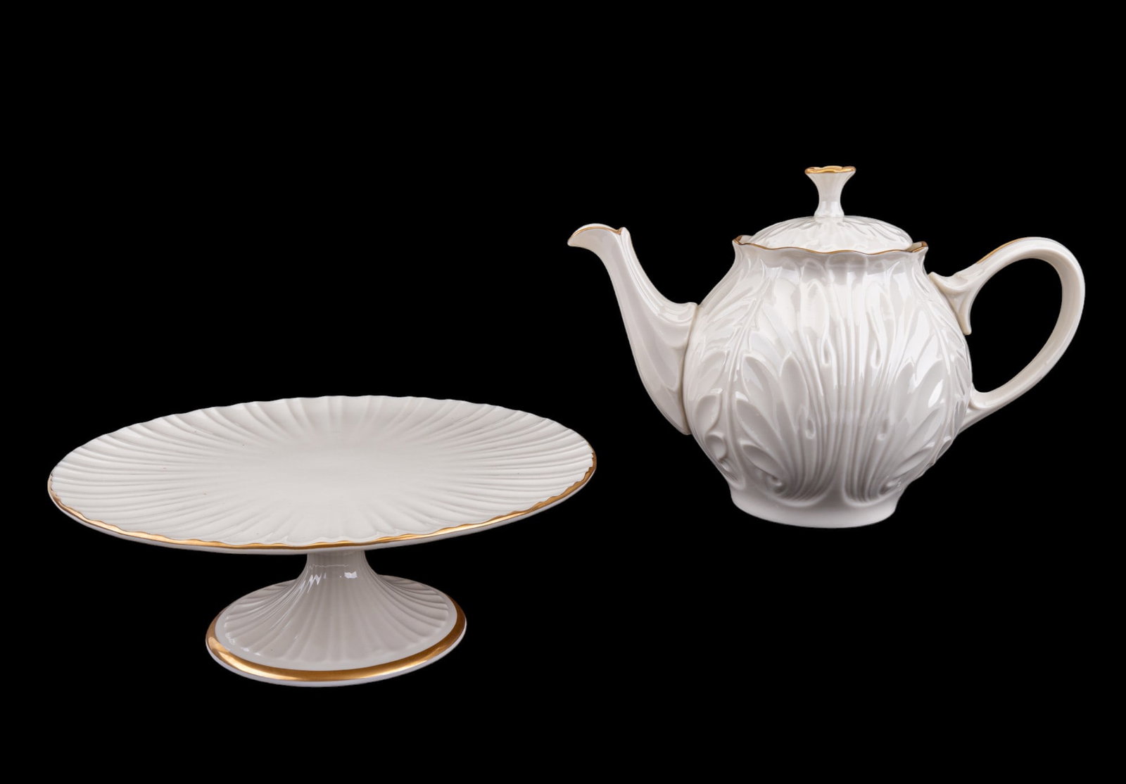 Lenox Teapot and Cake Stand: Lenox ivory and gold cake stand from the Plaza collection, 10.5x4" and an ivory and gold tea pot from the Cottage collection, 11x8".