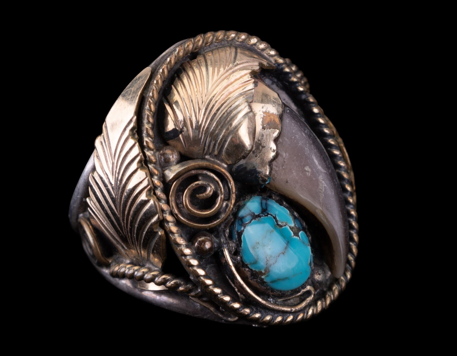 Native American Sterling Signed Ring: Vintage signed "S. Ray" sterling silver hand wrought bear claw turquoise ring accented by foliage detail.