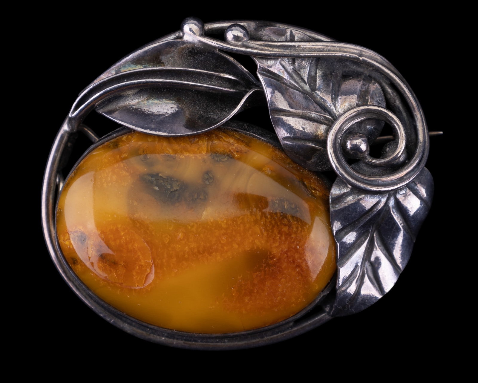 Sterling Amber Vintage Brooch: Sterling silver unmarked amber hand wrought with foliate details artisan brooch.