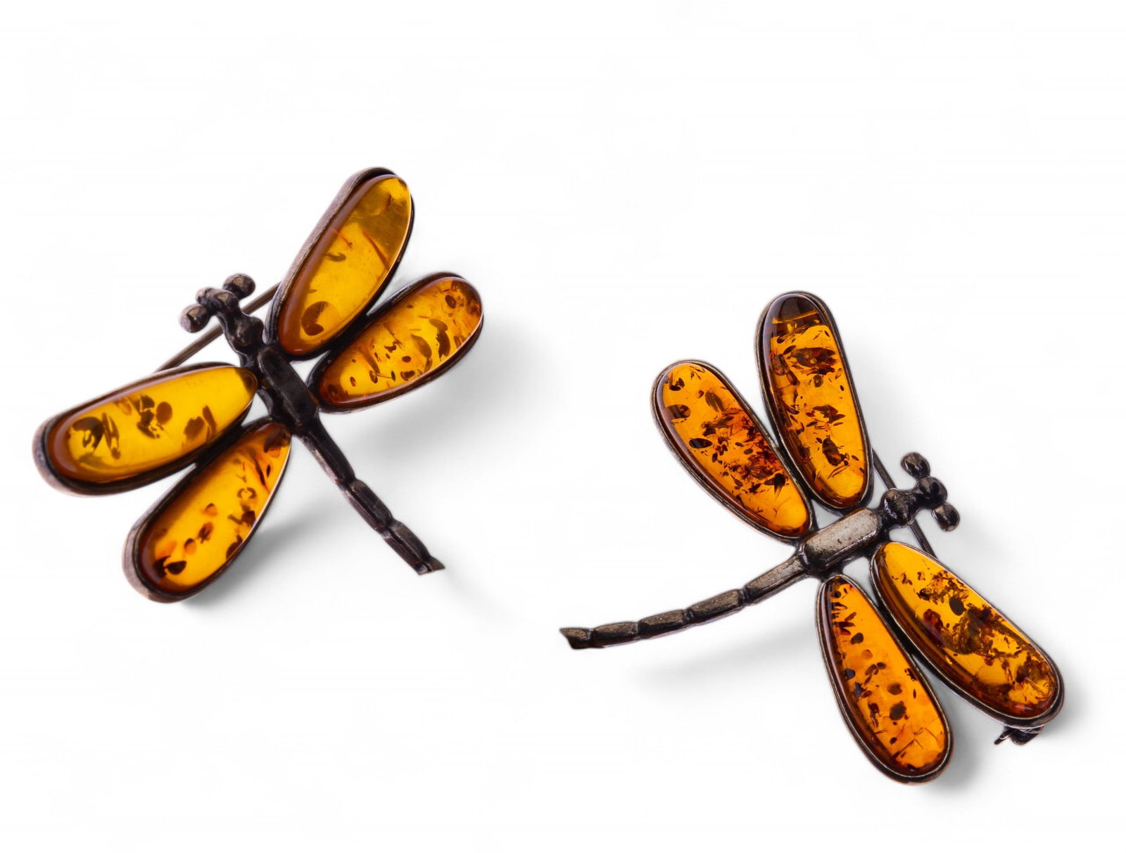 Pair of Russian Silver Amber Brooches: Pair of hallmarked Russian silver Baltic amber dragonflies with good inclusions.