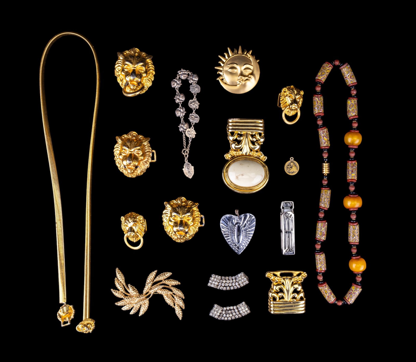 Vintage Jewelry Collection: Lion gold tone belt buckle pieces, brooches, signed "JJ" sun and moon and "Sarah Cov" large wheat, small perfume bottle, small icon pendant, and more.