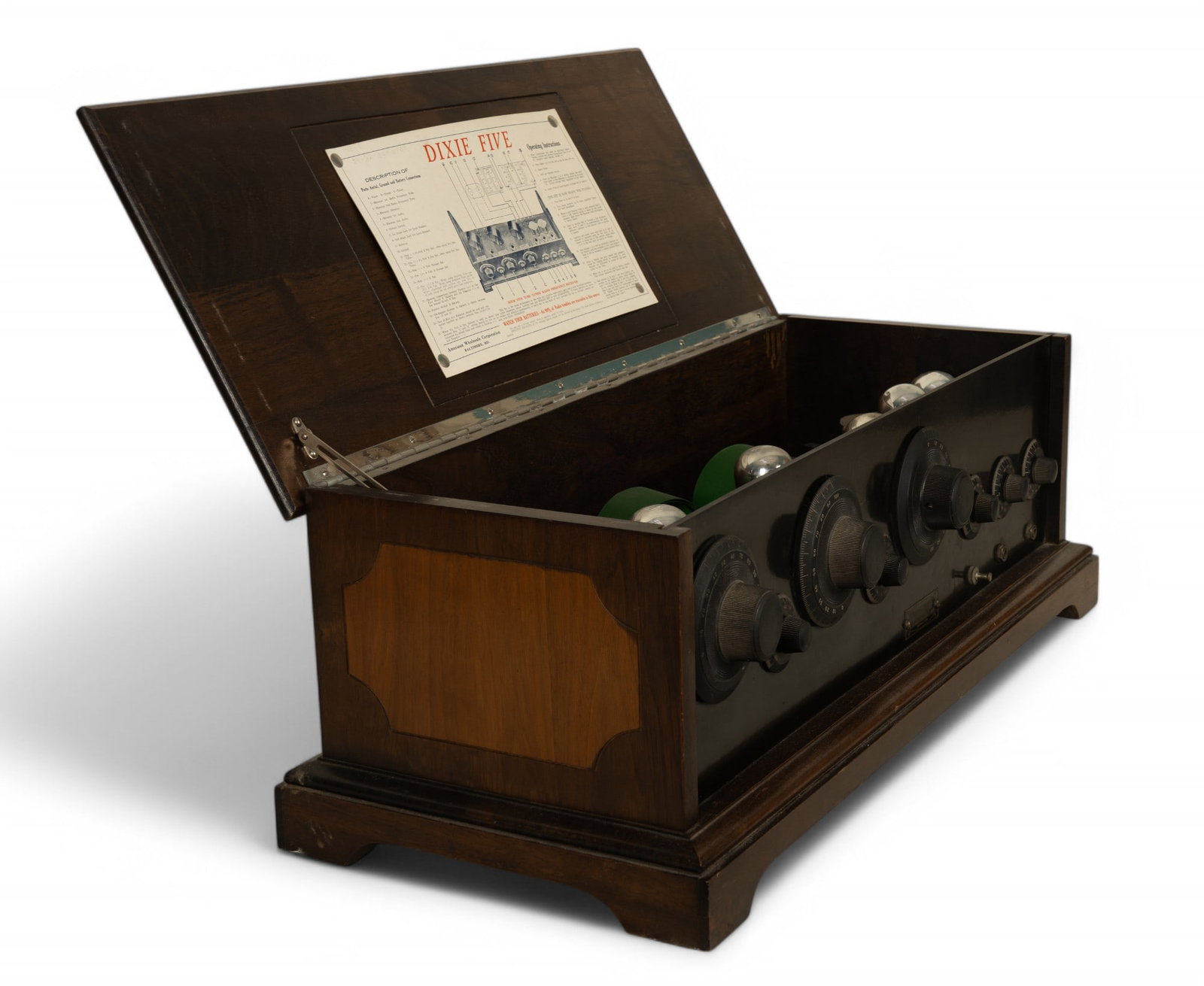Dixie Five Wooden Tube Radio Cabinet: Dixie Five wooden tube tuned radio frequency receiver cabinet manufactured by American Wholesale Corporation, Baltimore, MD. Dimensions are 28.5x12x10.5 inches. Features include a prominent front pane