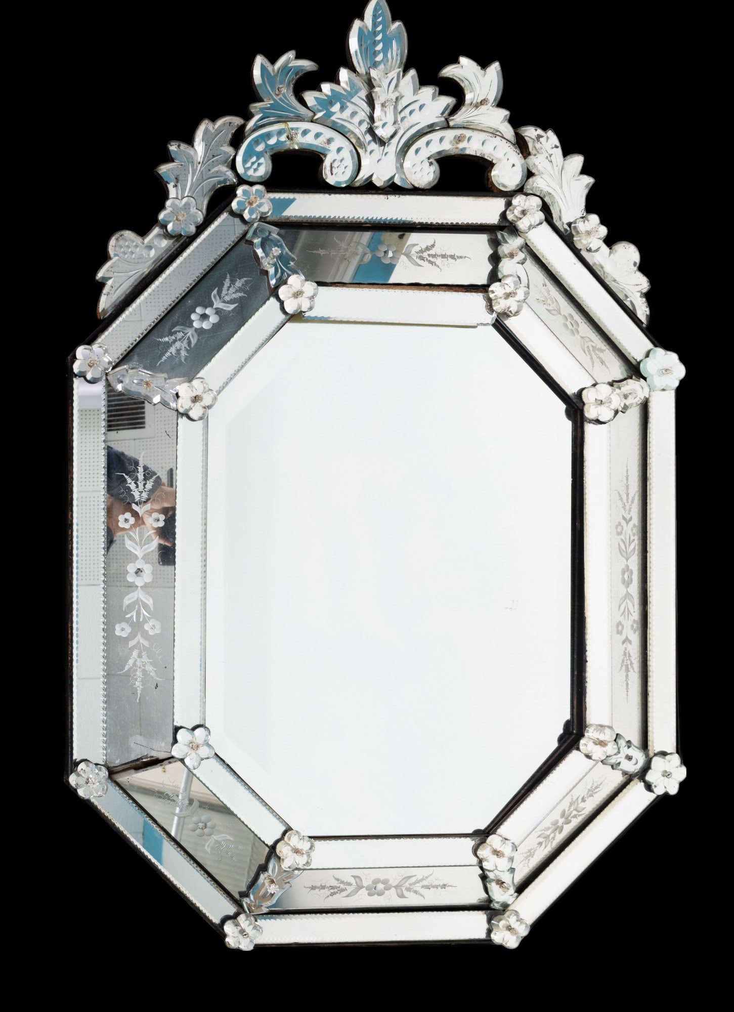 Venetian-Style Octagonal Mirror, 29?45 Inches: An elegant Venetian-style wall mirror featuring an octagonal shape. The mirror showcases beveled edges, etched floral detailing, and a decorative crest at the top. Measuring 29x45 inches, it is suitab
