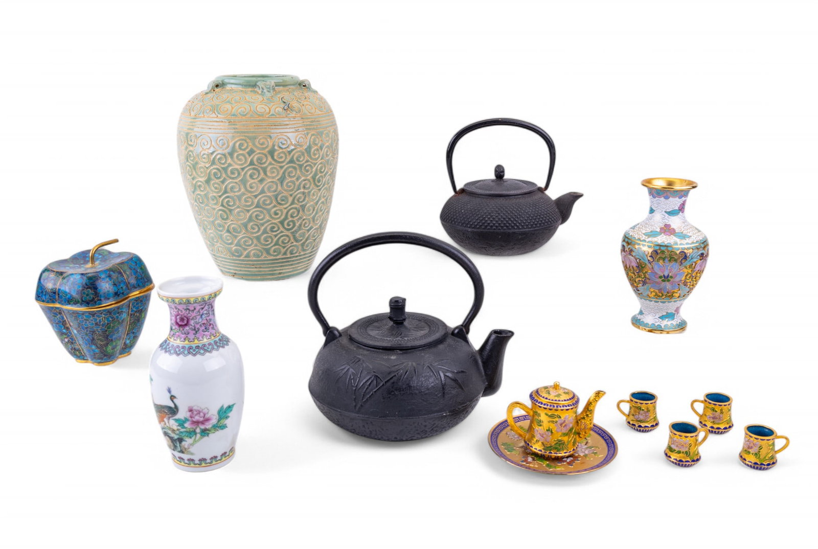 Celadon and Cloisonne Vases: A collection of decorative items, including two black cast iron teapots with detailed designs, such as bamboo motifs. Also included are an apple-shaped cloisonne trinket box with lid, 5", a ceramic va
