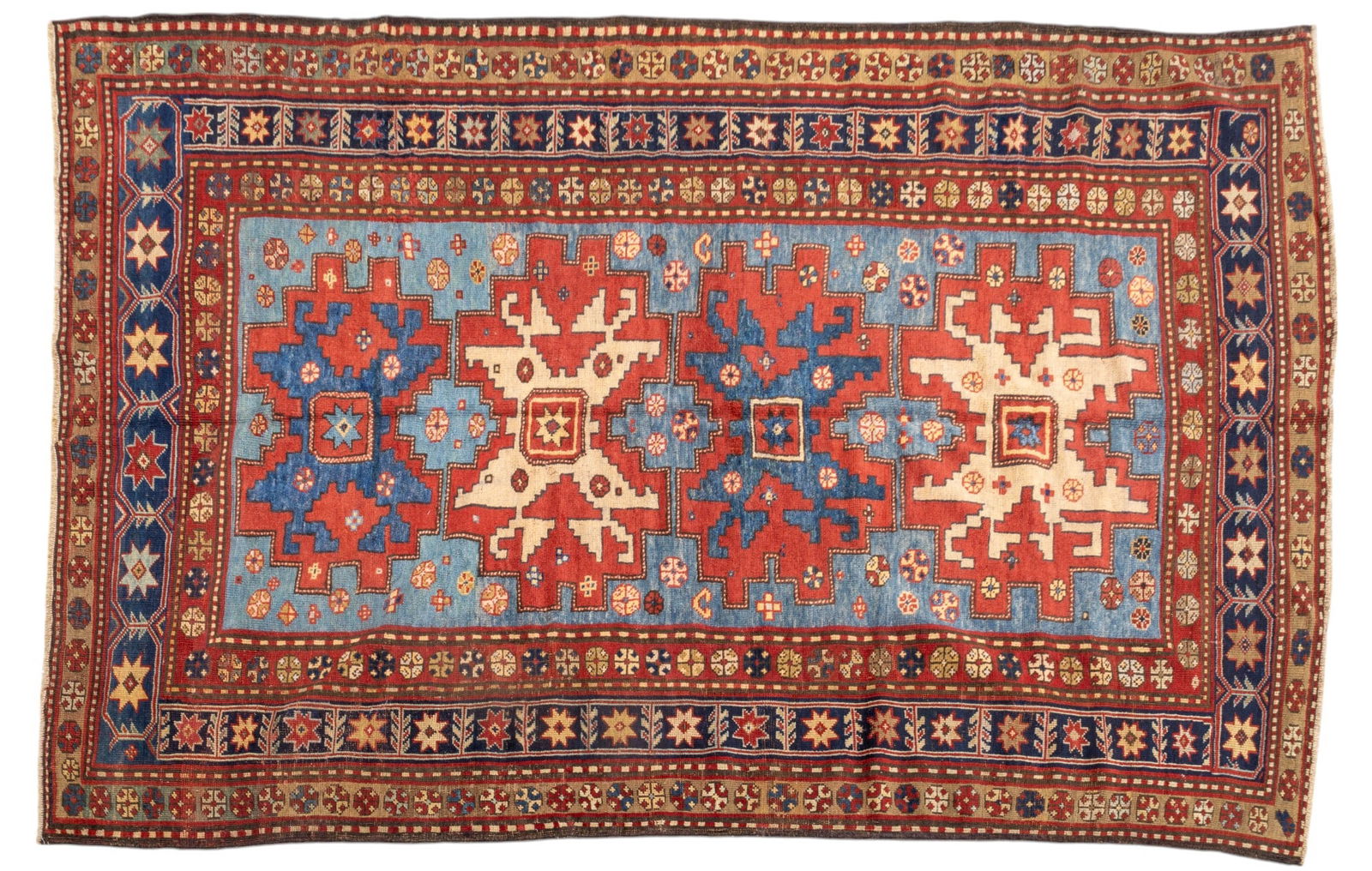 Antique Kazak Rug: Antique Kazak rug approx. 5'5" x 8'6" w/ red, livid blue-gray, navy blue, brown, tan, & ivory patterns w/ geometric & floral motifs. *All rugs / carpets are used & come from fine estates. Keystone Auc