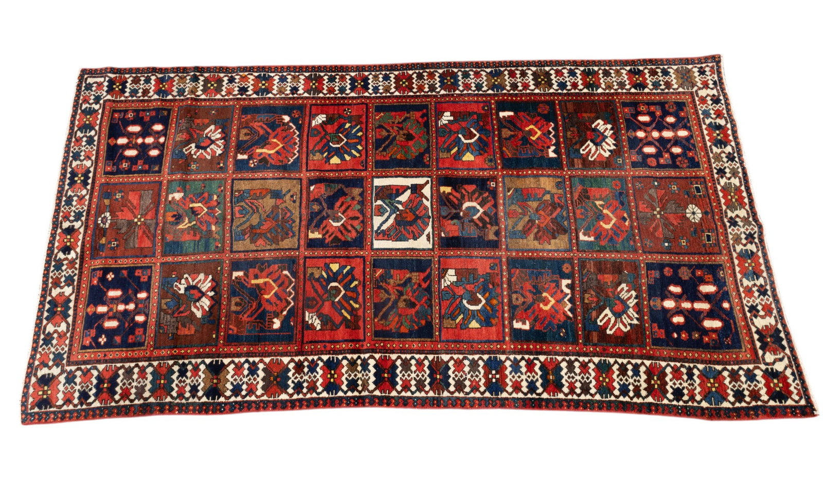 Bakhtiari Garden Design Rug: Bakhtiari rug approx. 5'3" x 10'3" w/ red, dark blue, brown, tan, & ivory garden design that features geometric & floral patterns. *All rugs / carpets are used & come from fine estates. Keystone Aucti