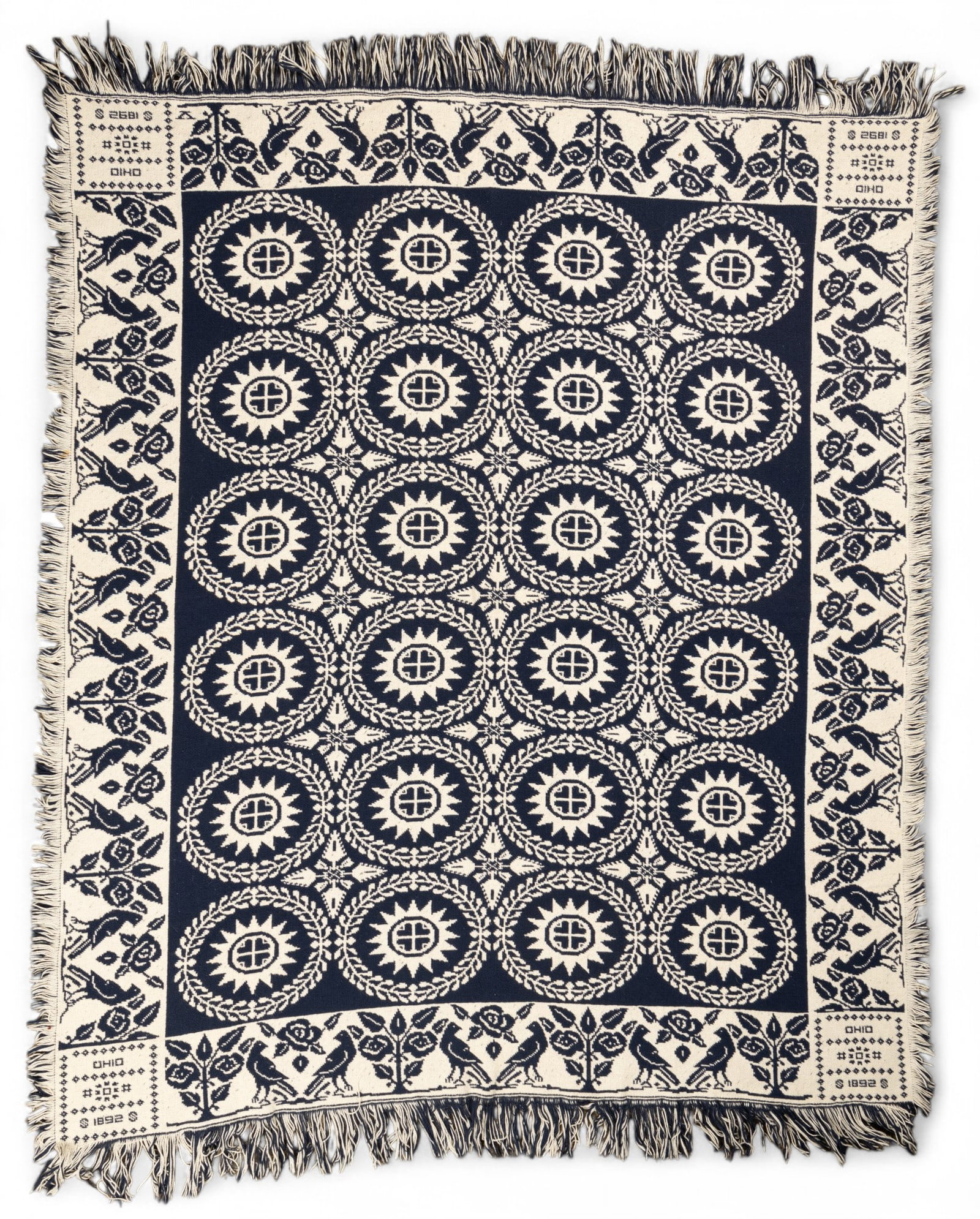 Ohio 1892 Woven Youth Coverlet, Approx 4' x 4.5': A woven youth coverlet measuring 44 x 55 inches, marked 'Ohio 1892'. Features detailed floral and geometric motifs in contrasting colors, with fringe along the edges. Appears to have been crafted usin