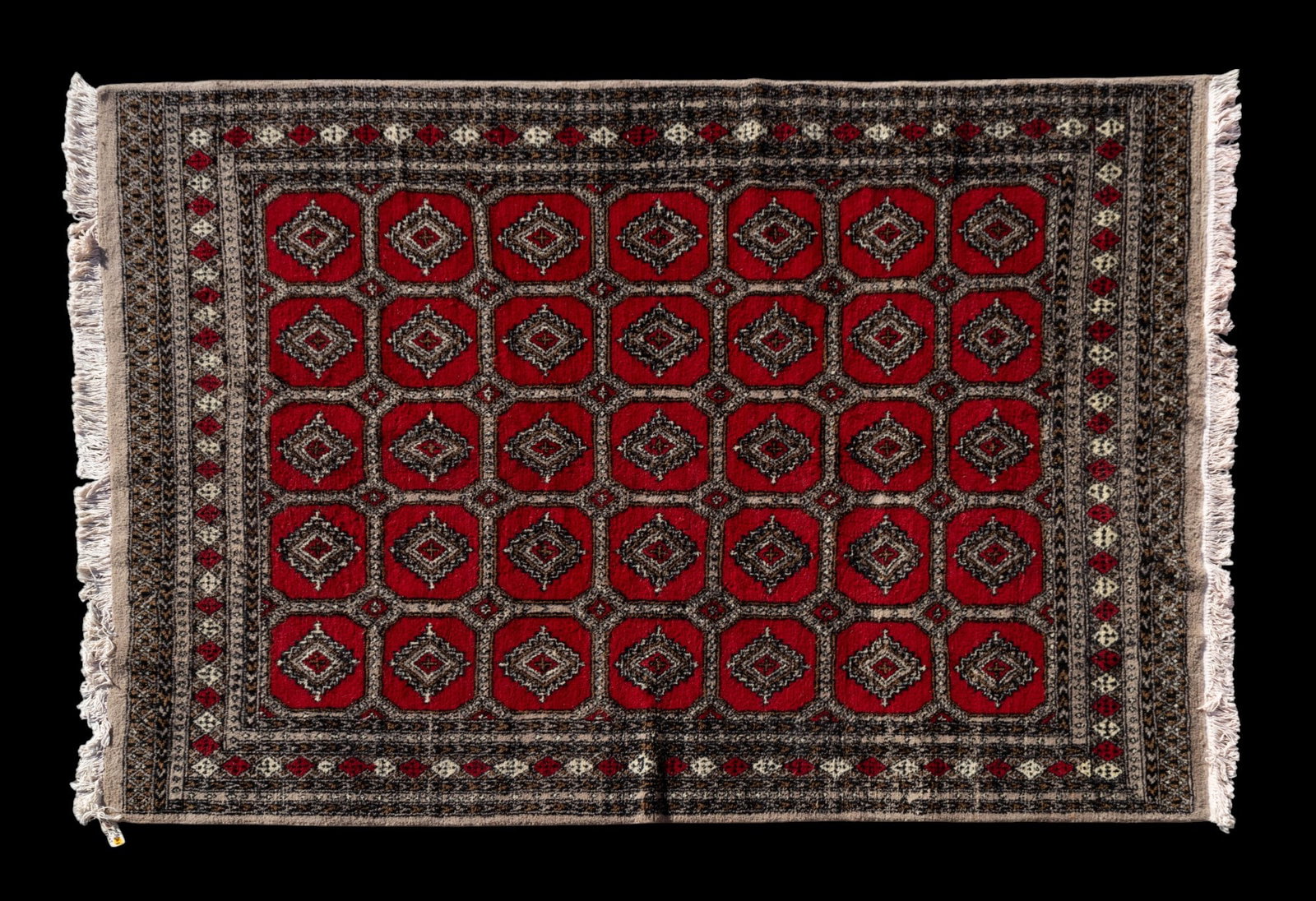 Pakistan Bokhara Rug: Pakistan Bokhara rug approx. 6'2" x 8'8" w/ red, brown, tan, gray, ivory, & black patterns w/ geometric motifs. *All rugs / carpets are used & come from fine estates. Keystone Auctions does not clean 