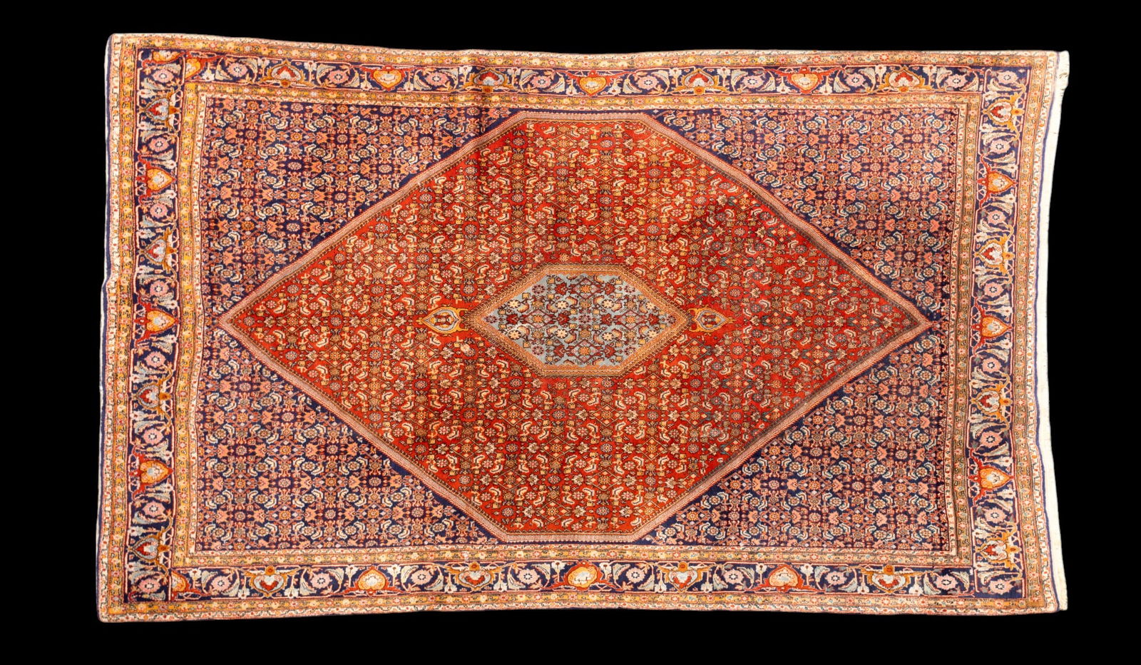 Persian Bidjar Rug: Persian Bidjar rug approx. 7'4" x 11'6" w/ red-orange, burnt orange, pink, navy blue, livid bluish-gray, gold, tan, black, & ivory patterns w/ floral motifs. Some fading. *All rugs / carpets are used