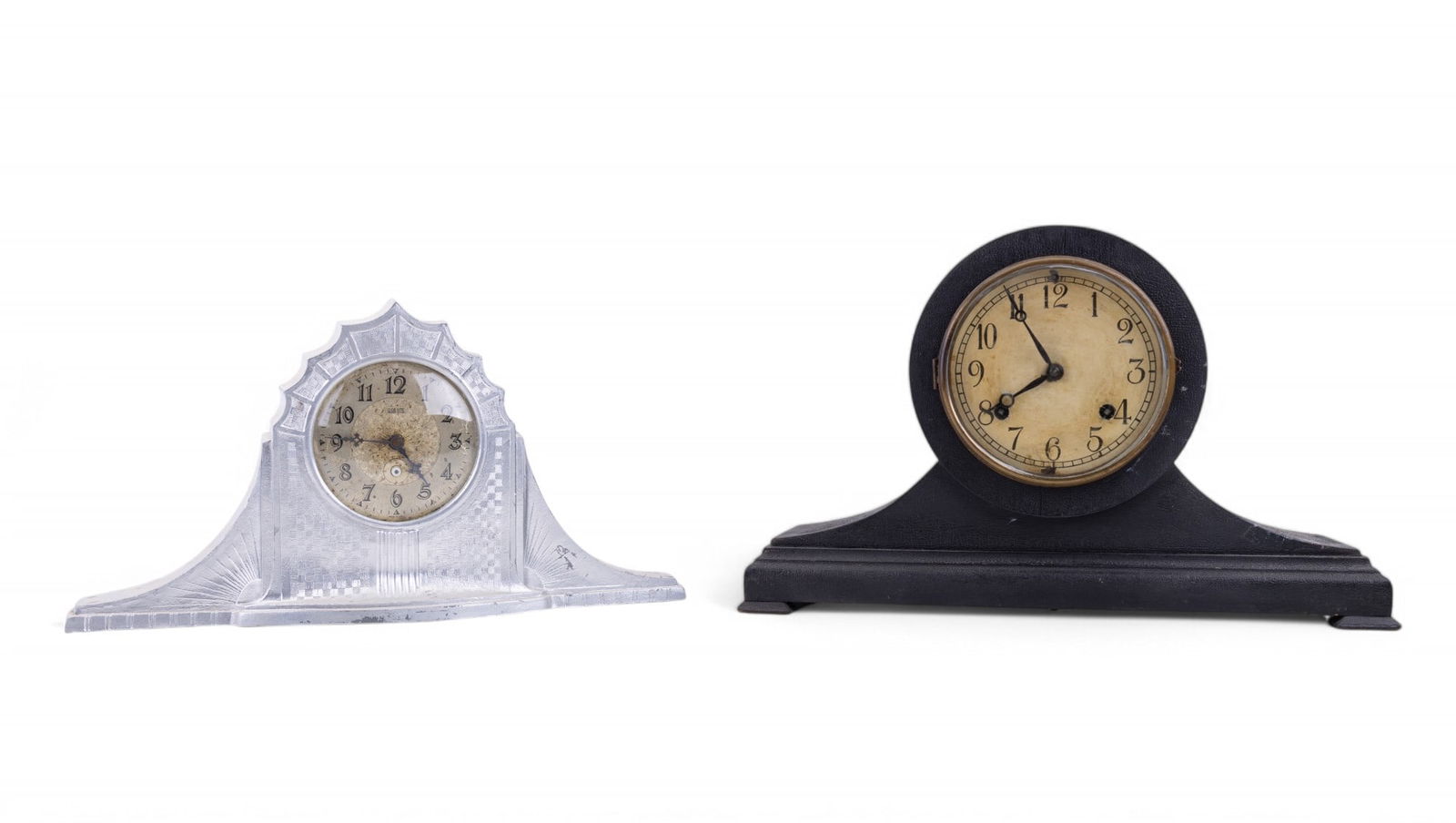 USA Lite Electric Mantel Clock + Other Mantel: USA Lite electric silver tone mantel clock w/ detailed clock face & a pendulum mantel clock made of black-painted wood. USA Lite clock has some scratching to silver coat. Wood mantel clock has key inc