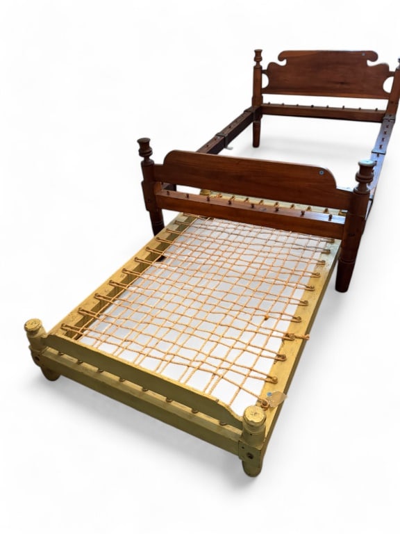 19th C Thistle Top Rope Bed & Painted Trundle Bed: 19th C thistle top rope bed measures approx. 38" H x 51.5" W x 81.5" D - mattress approx. 44" W x 75" L. Painted trundle bed measures approx. 15" H x 41.5" W x 67" L.