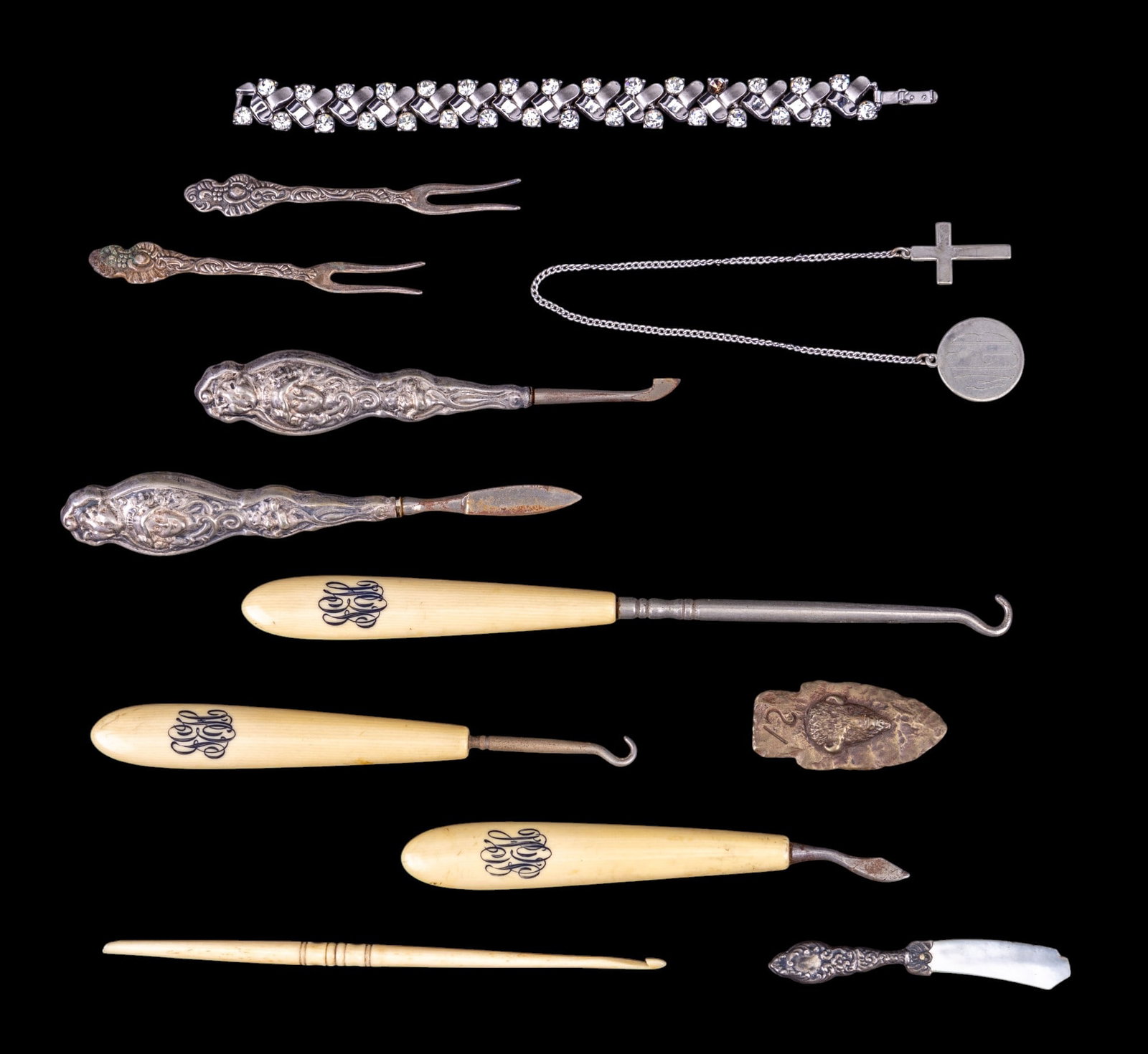 Silver Tone Grooming Tools and Utensils: Silver tone and rhinestone Trifari tennis bracelet, vintage ncross pendant with monogramed medallion, craved naturl material crochet hook, monogrammed polished bone handle button hooks and manicure kn
