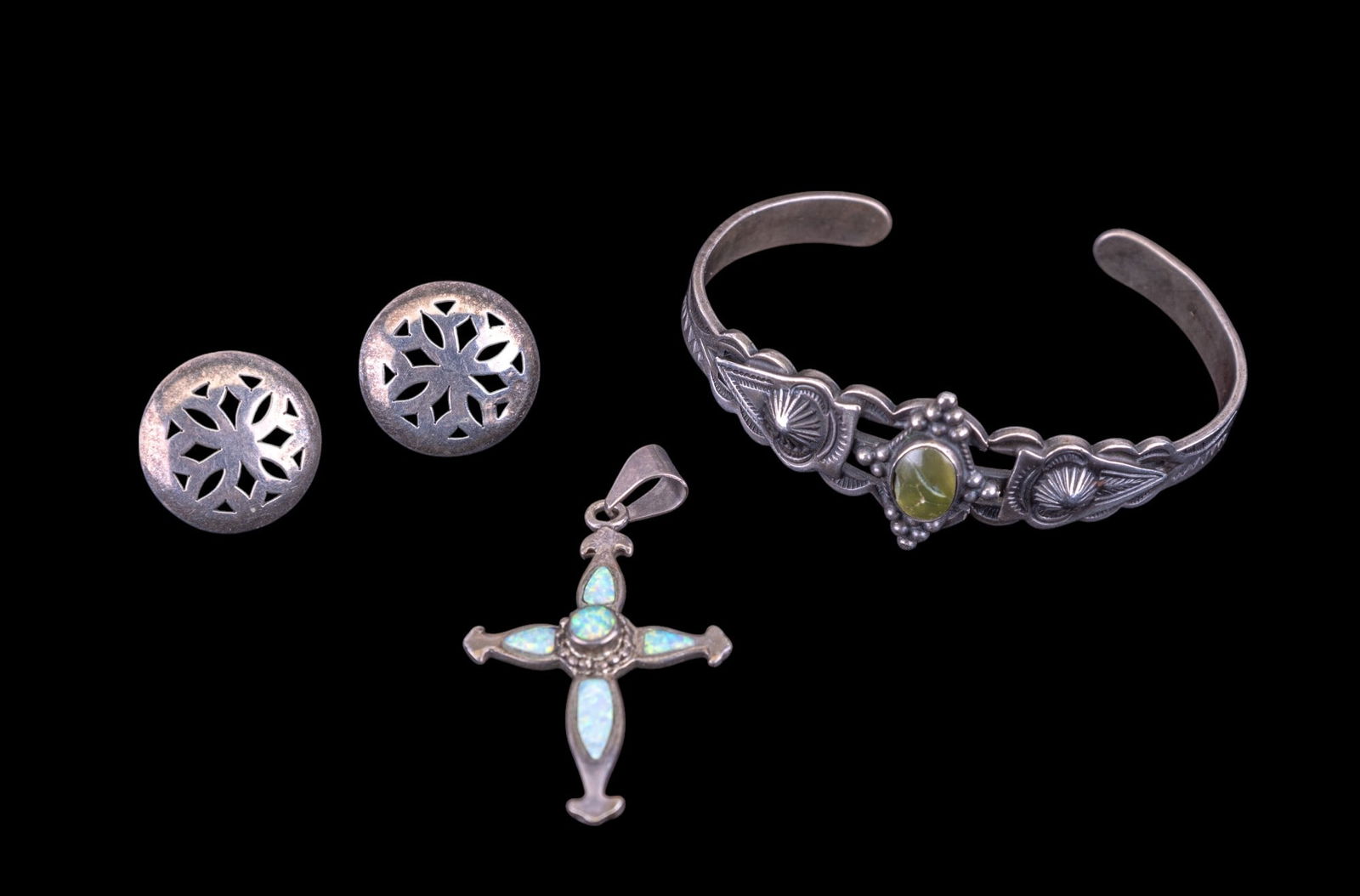 Native American Sterling Jewelry: Signed sterling 'Silverbird' stud earrings, sterling and opal Cross pendant, and an etched unmarked cuff bracelet with green stone cabochon, note break on the back of the bracelet.