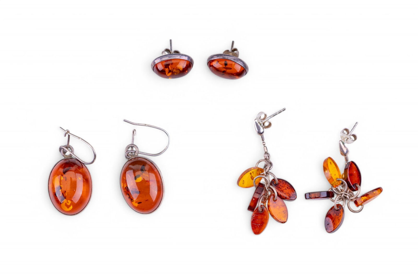 Baltic Amber Sterling Earrings: Three pairs of Baltic amber and sterling earrings featuring studs, drop, and dangling earring styles.