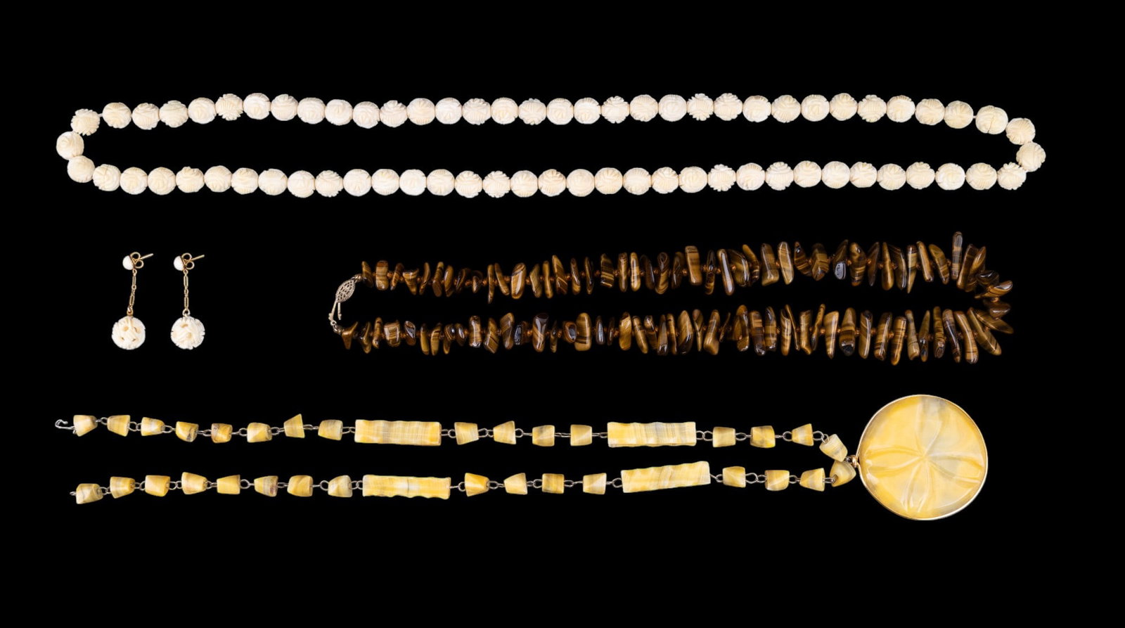 Tigers Eye and Estate Necklaces: Polished chunk, tigers eye necklace, carved stone necklace, and carved floral necklace with a pair of earrings .