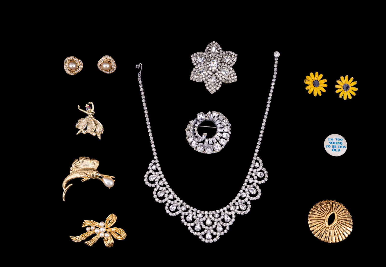 Trifari Brooches and Vintage Jewelry: Trifari gold tone sailfish, c 1950s, sunburst, and bow and pearls brooches, vintage Pop Art daisy clip on earrings, pearl and crystal clip on earrings, stamp is illegible, clear rhinestone crystal nec