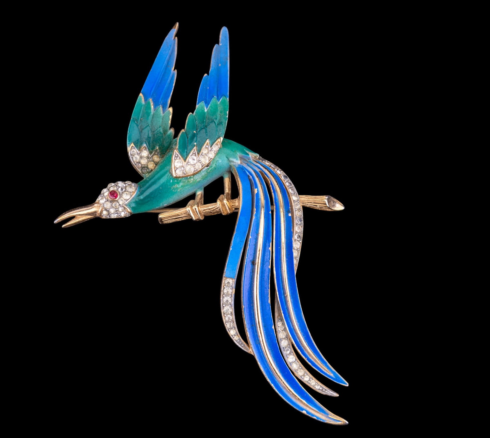 Trifari Designer Brooch: Vintage Trifari gold tone with blue and green enamel bird of paradise brooch with crystal gem accents.