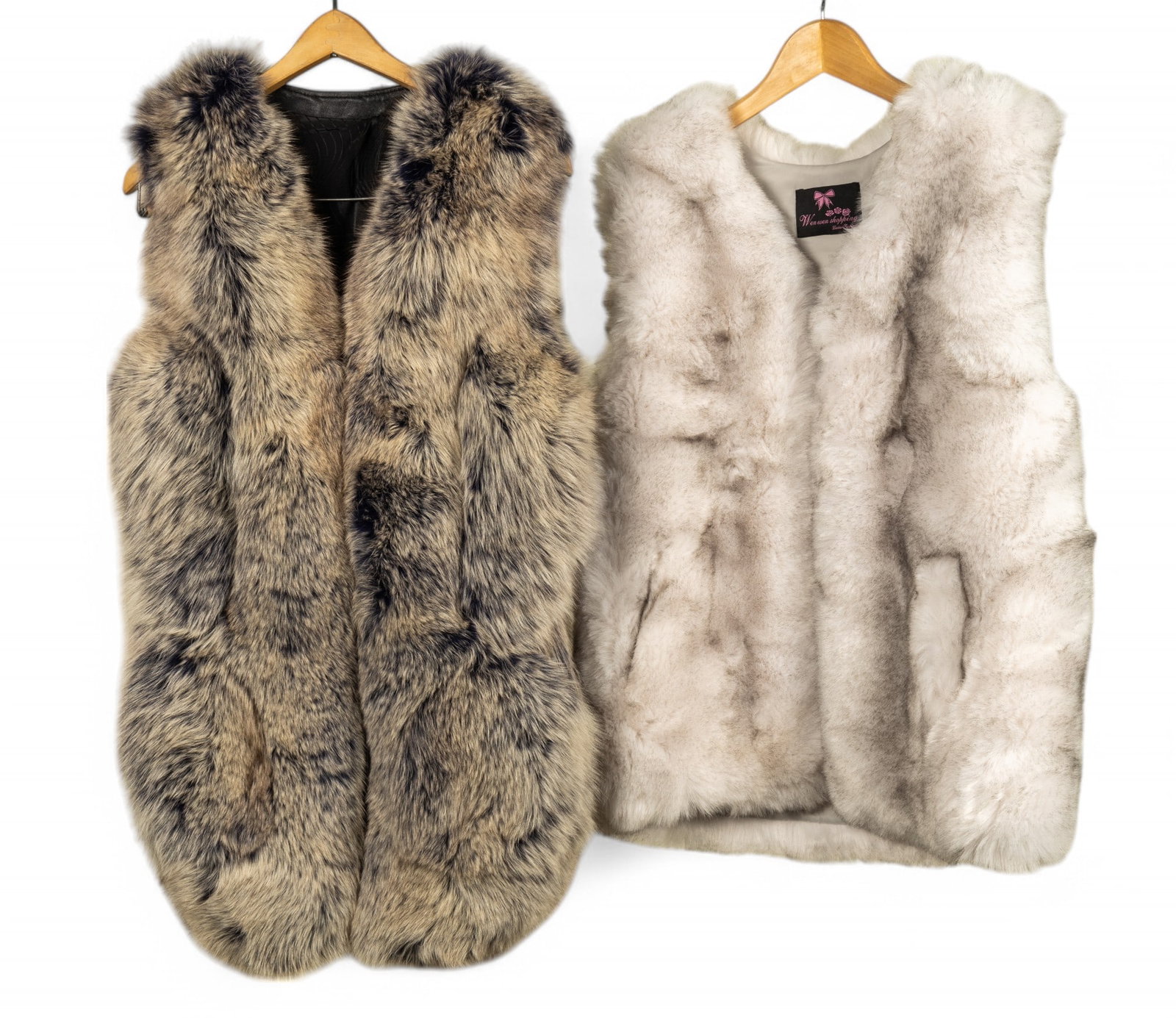 Faux Fur Vests by Wen Wen and Betty Blue Spa: Two faux fur vests. One is estimated to be size medium-large by Wen Wen measuring approx. 25" long x 20" at mid, and the other is a size 4 by Betty Blue Spa in blue tones and measuring approx 18" x 32