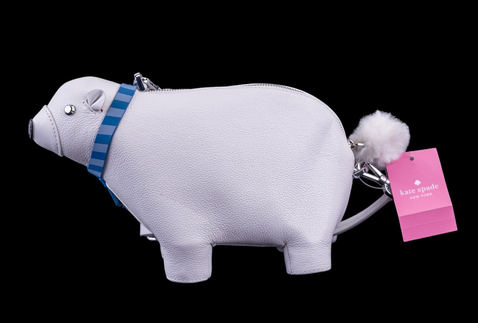 Kate Spade Polar Bear Bag Metallic Finish: Kate Spade crossbody bag designed in the shape of a polar bear. Constructed of white textured material with a metallic finish, accented by a blue striped scarf detail and a pom-pom tail. The bag featu